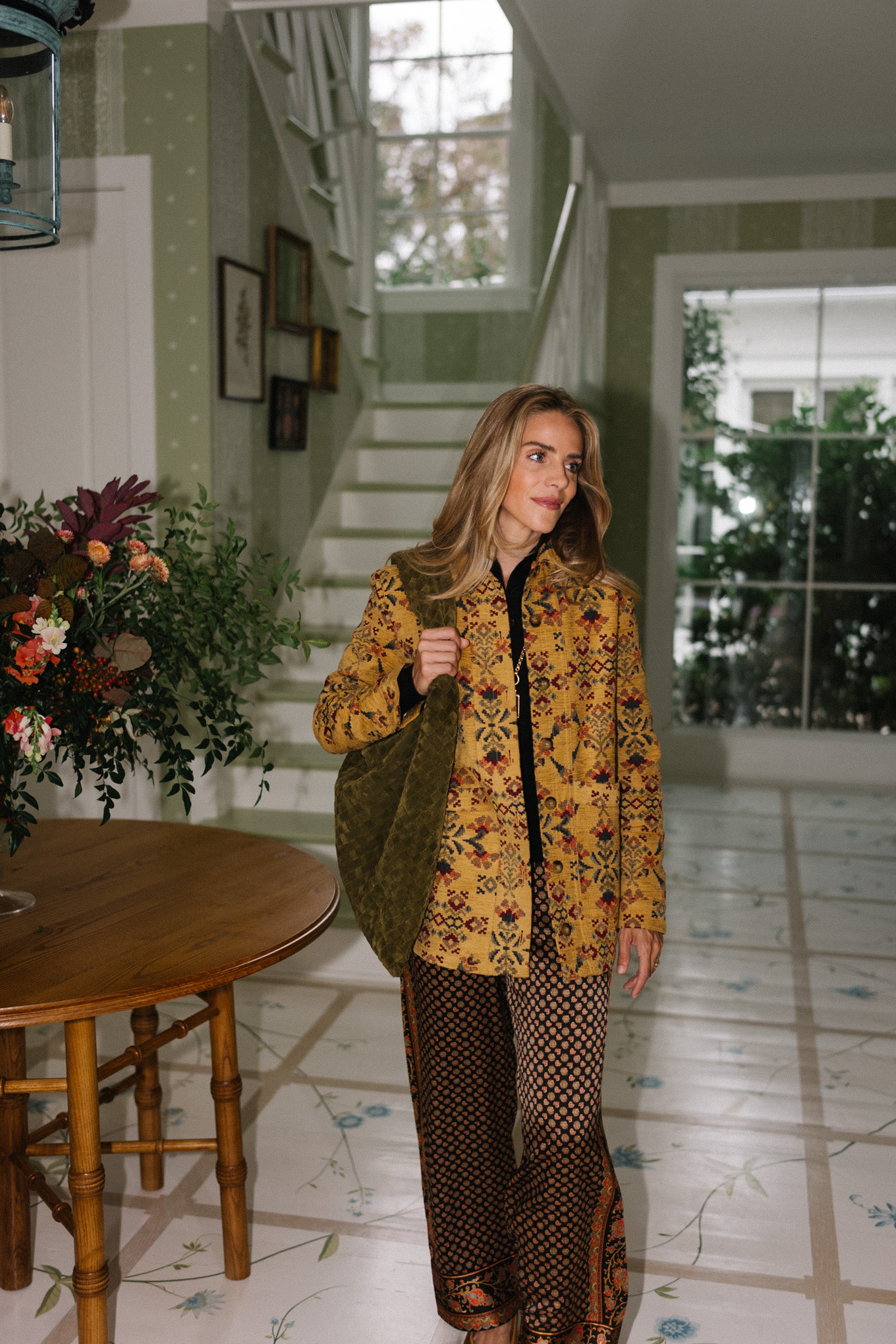 gold embroidered jacket brown silk patterned pants green suede hobo bag