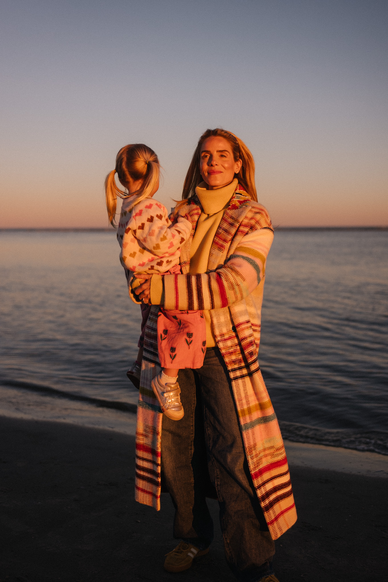 rainbow stripe coat yellow turtleneck sweater blue jeans yellow sneakera