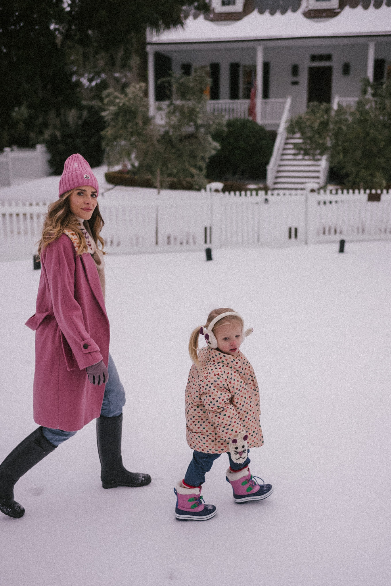 pink wool coat pink beanie blue denim snow gear