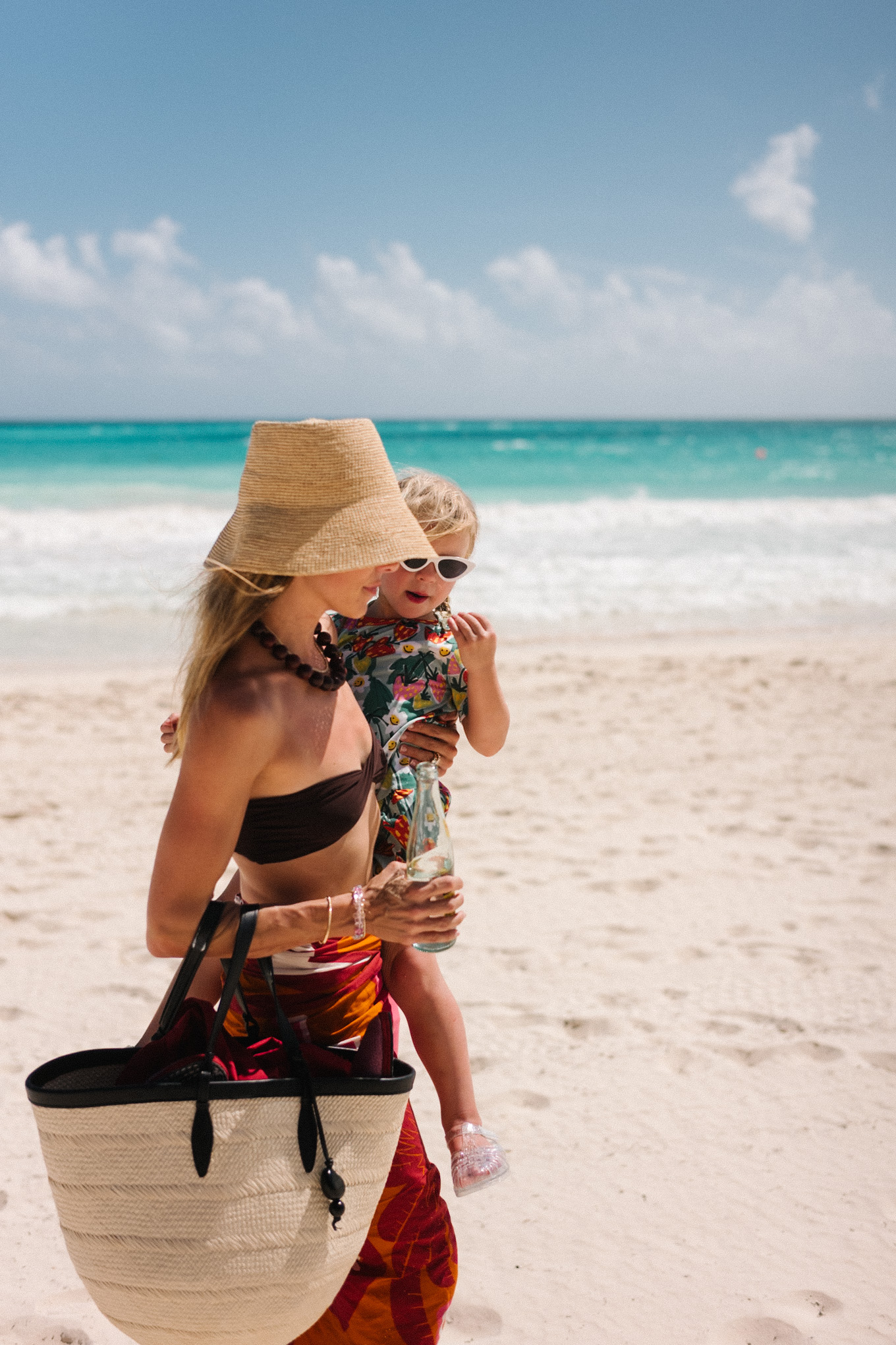 brown bikini straw hat brown bead necklace pink orange pareo