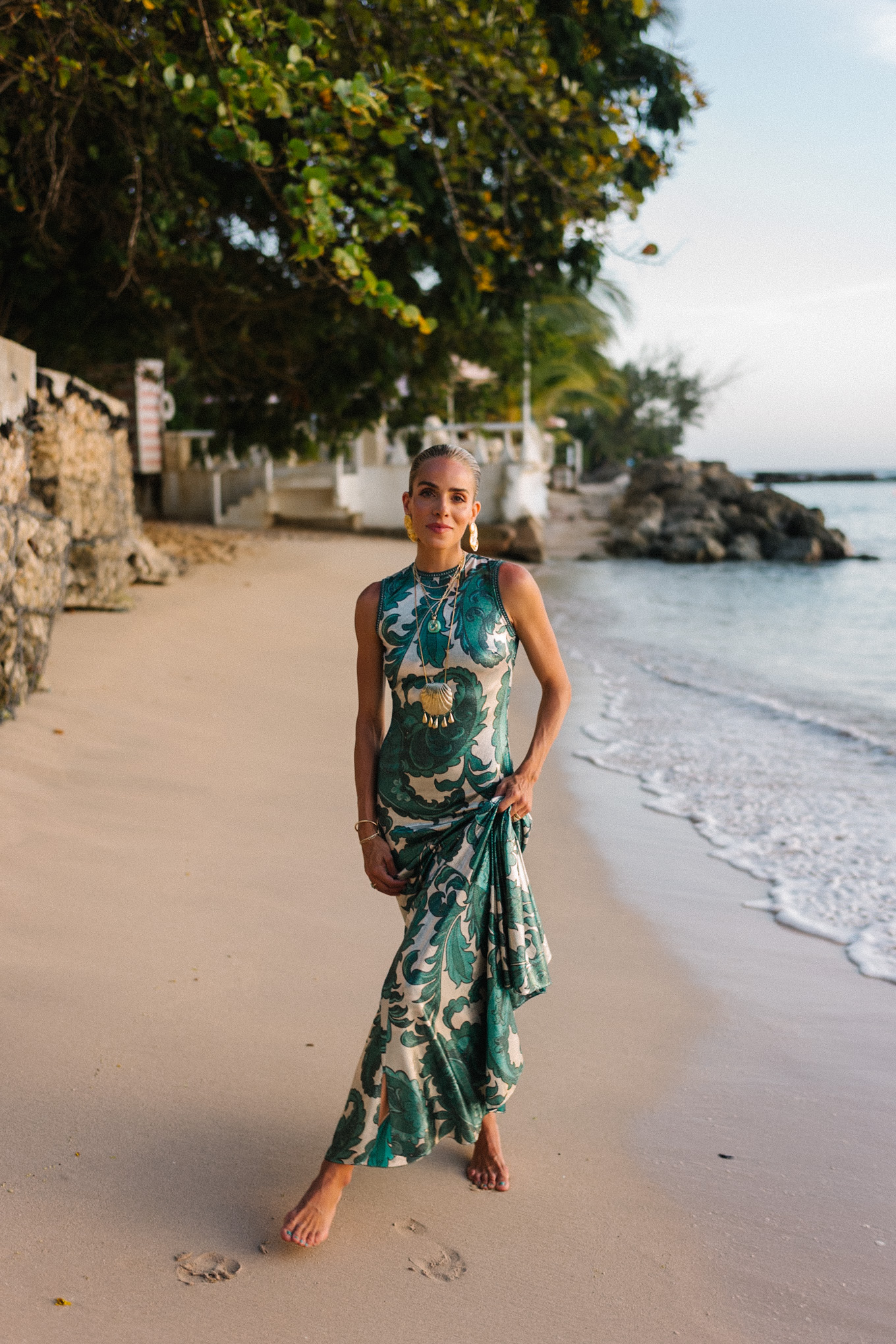 Barbados Sparkly Green Paisley Maxi Dressed in gold slopes of gold fabric bag