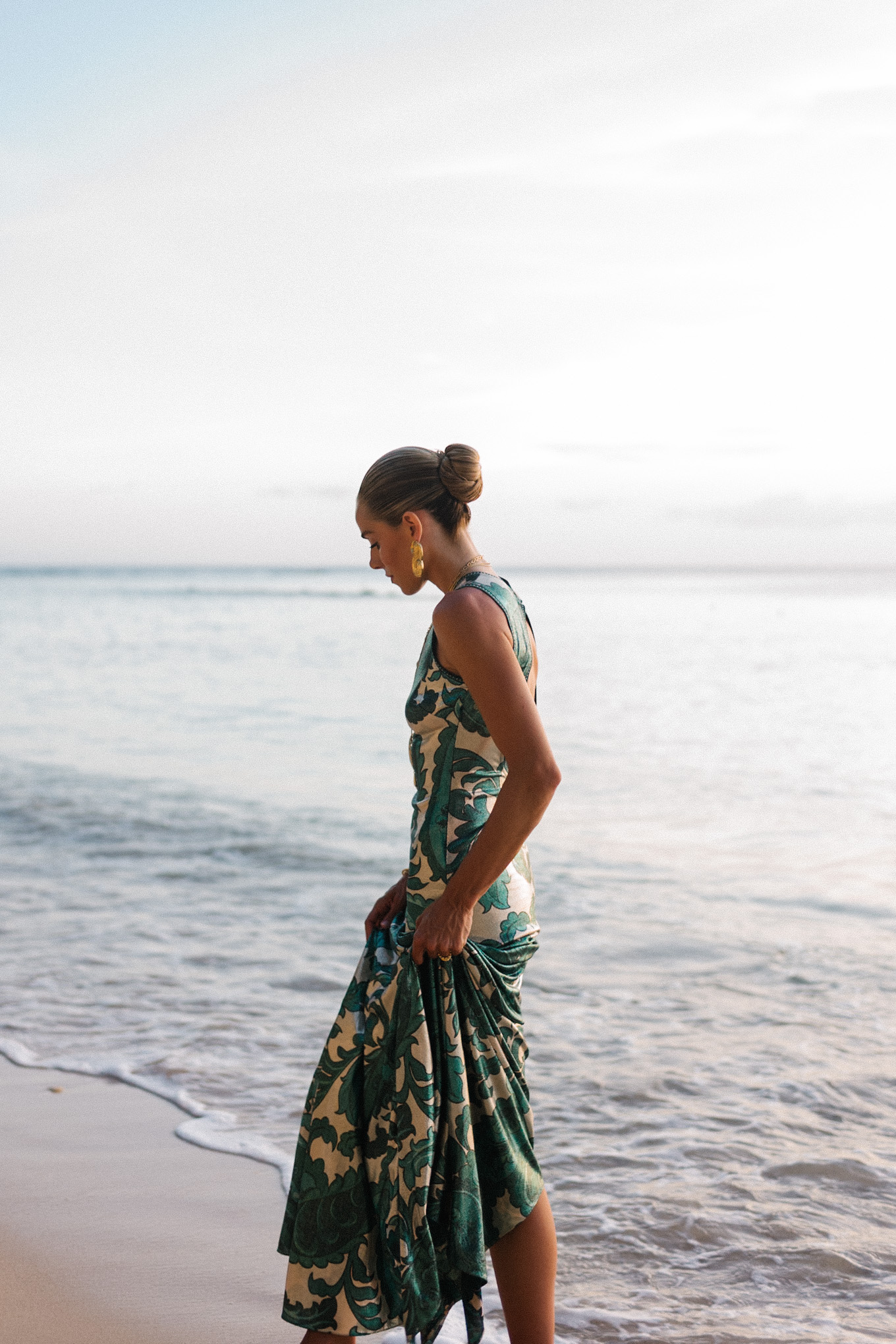Barbados Sparkly Green Paisley Maxi Dressed in gold slopes of gold fabric bag