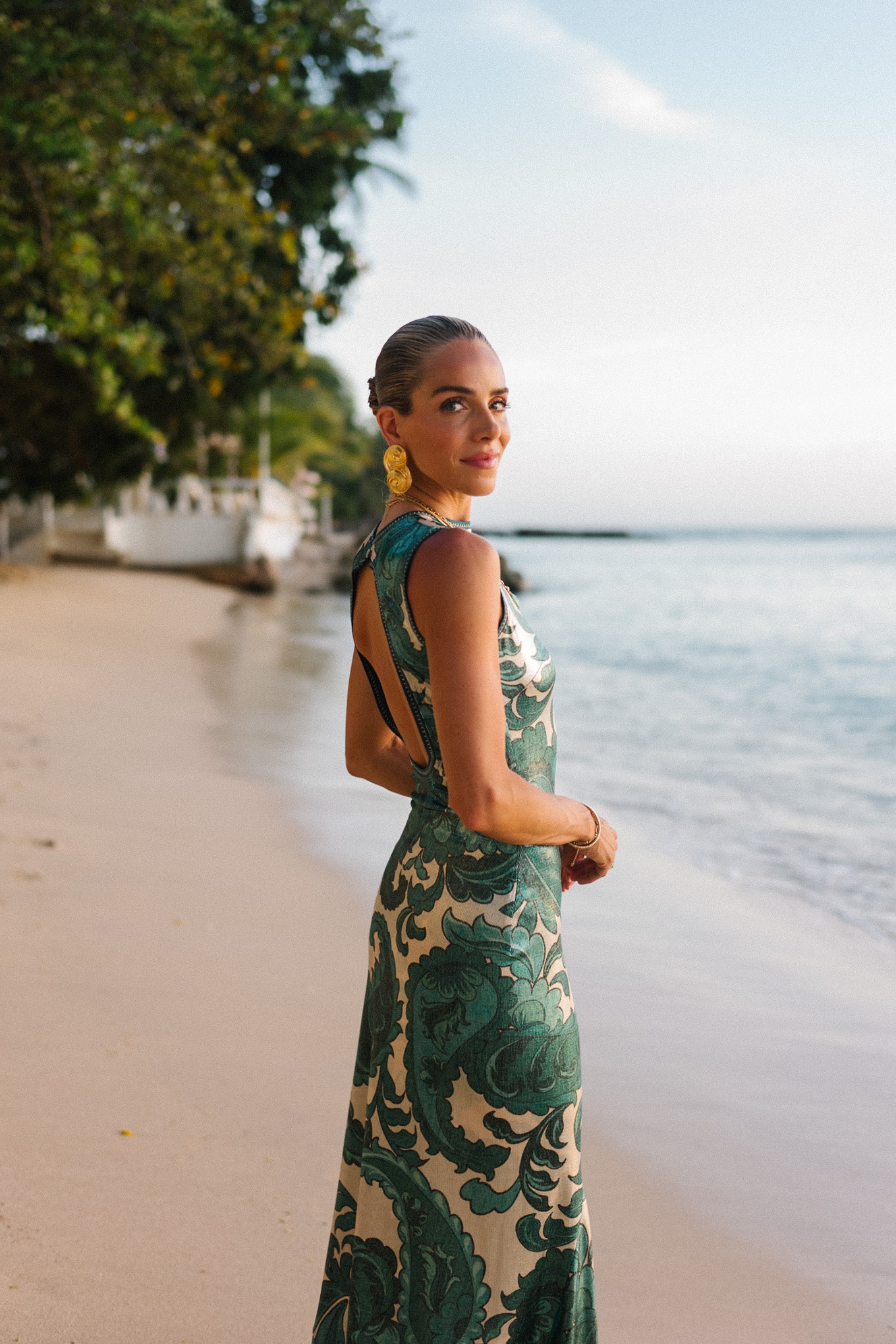 Barbados Sparkly Green Paisley Maxi Dressed in gold slopes of gold fabric bag