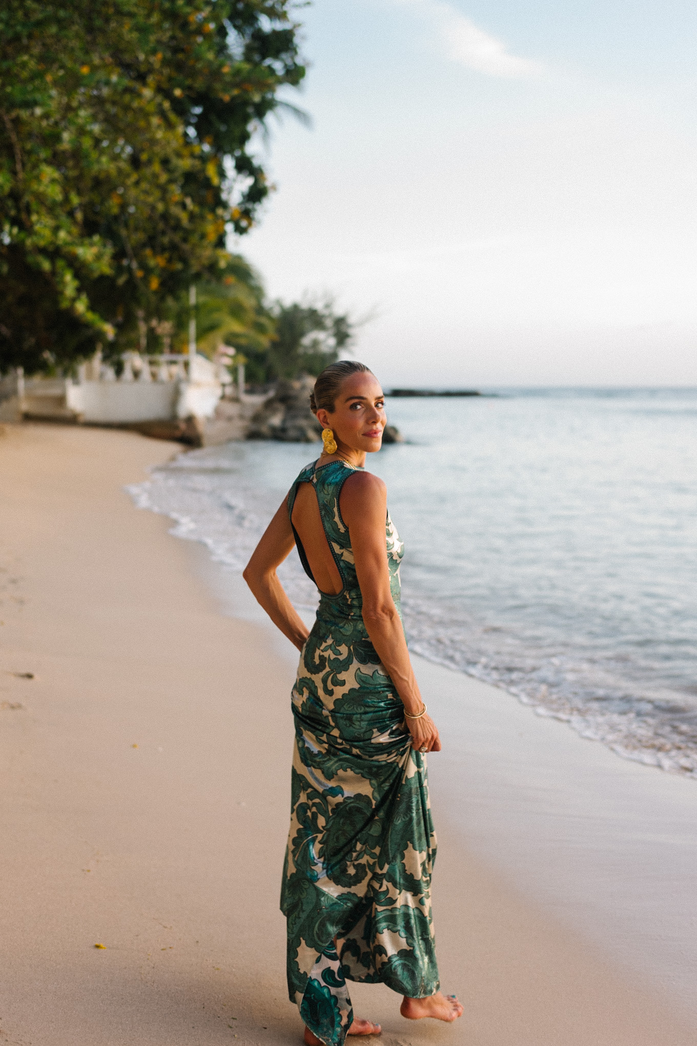 Barbados Sparkly Green Paisley Maxi Dressed in gold slopes of gold fabric bag
