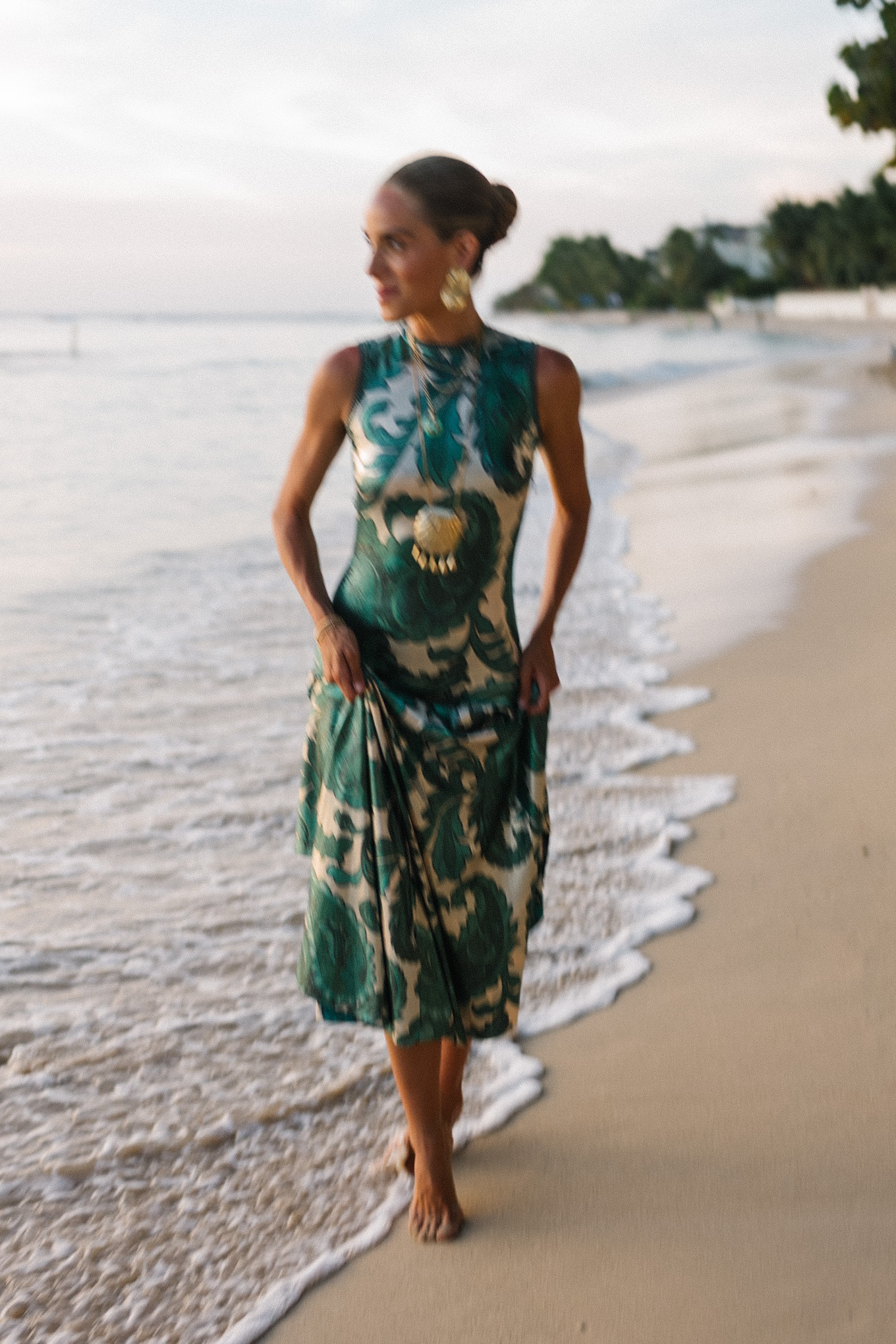 Barbados Sparkly Green Paisley Maxi Dressed in gold slopes of gold fabric bag