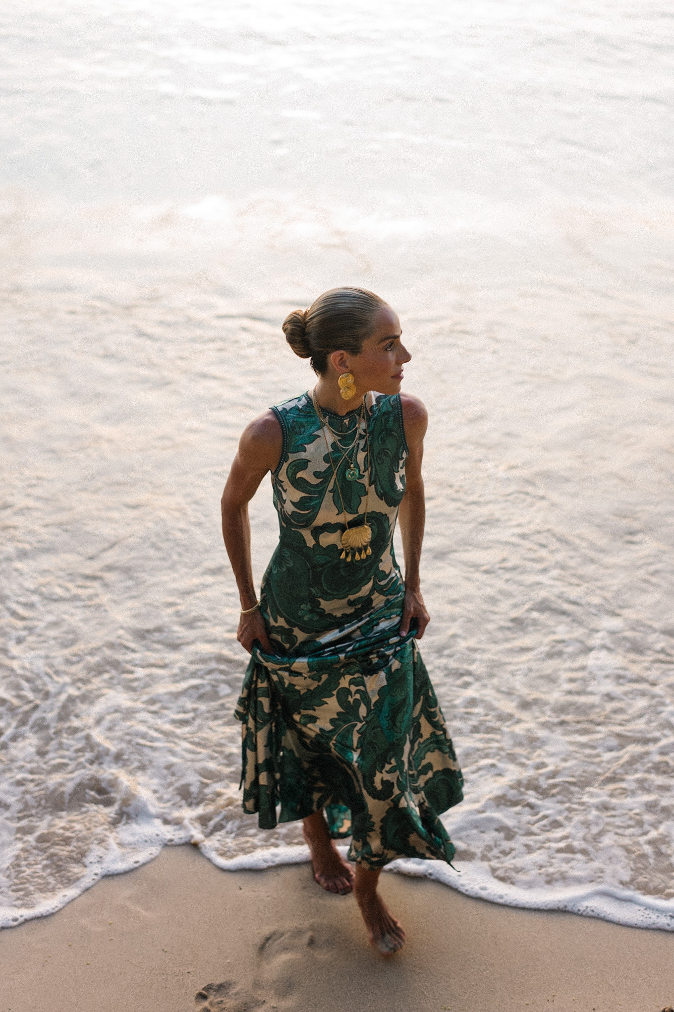 Barbados Sparkly Green Paisley Maxi Dressed in gold slopes of gold fabric bag