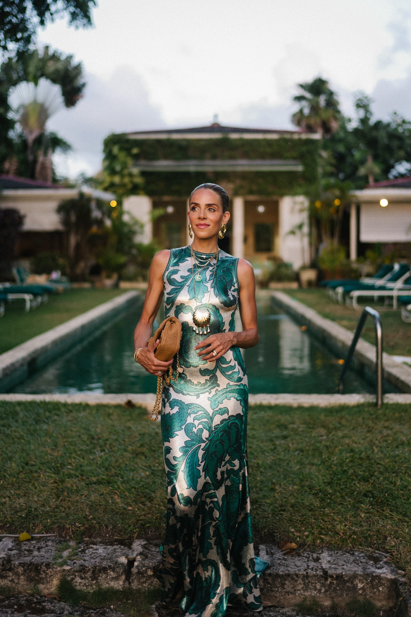 Barbados Sparkly Green Paisley Maxi Dressed in gold slopes of gold fabric bag