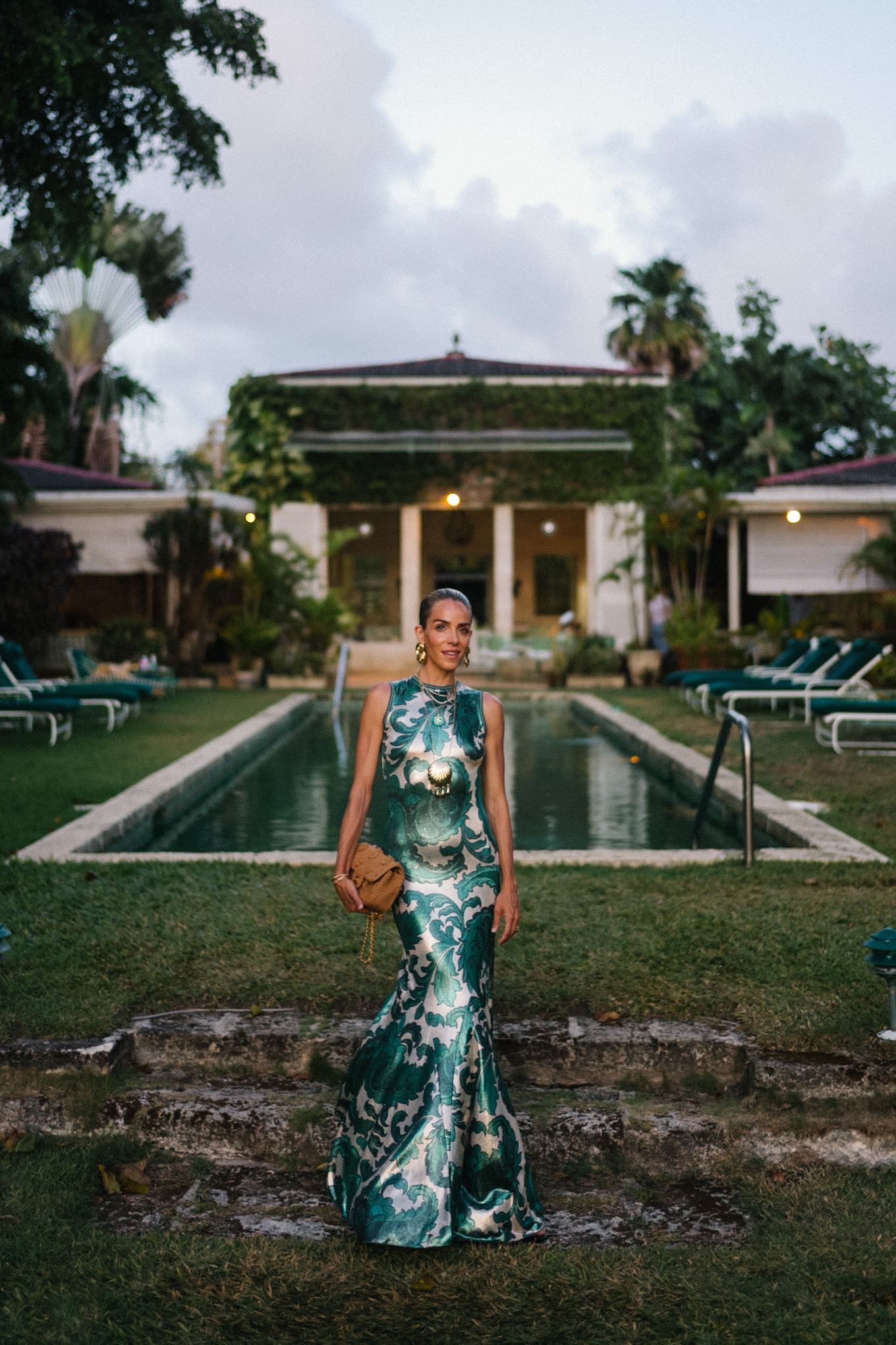 Barbados Sparkly Green Paisley Maxi Dressed in gold slopes of gold fabric bag