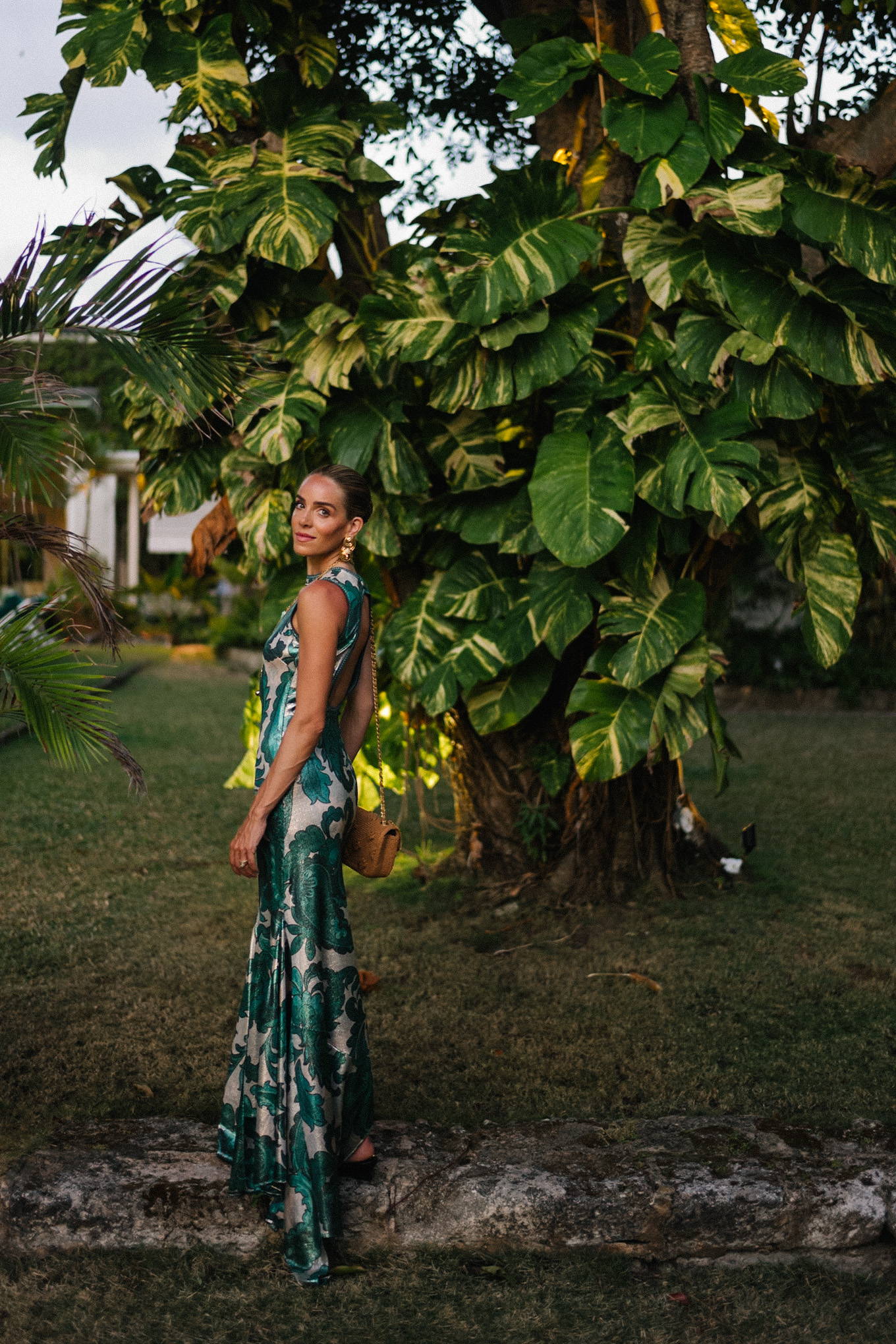 Barbados Sparkly Green Paisley Maxi Dressed in gold slopes of gold fabric bag