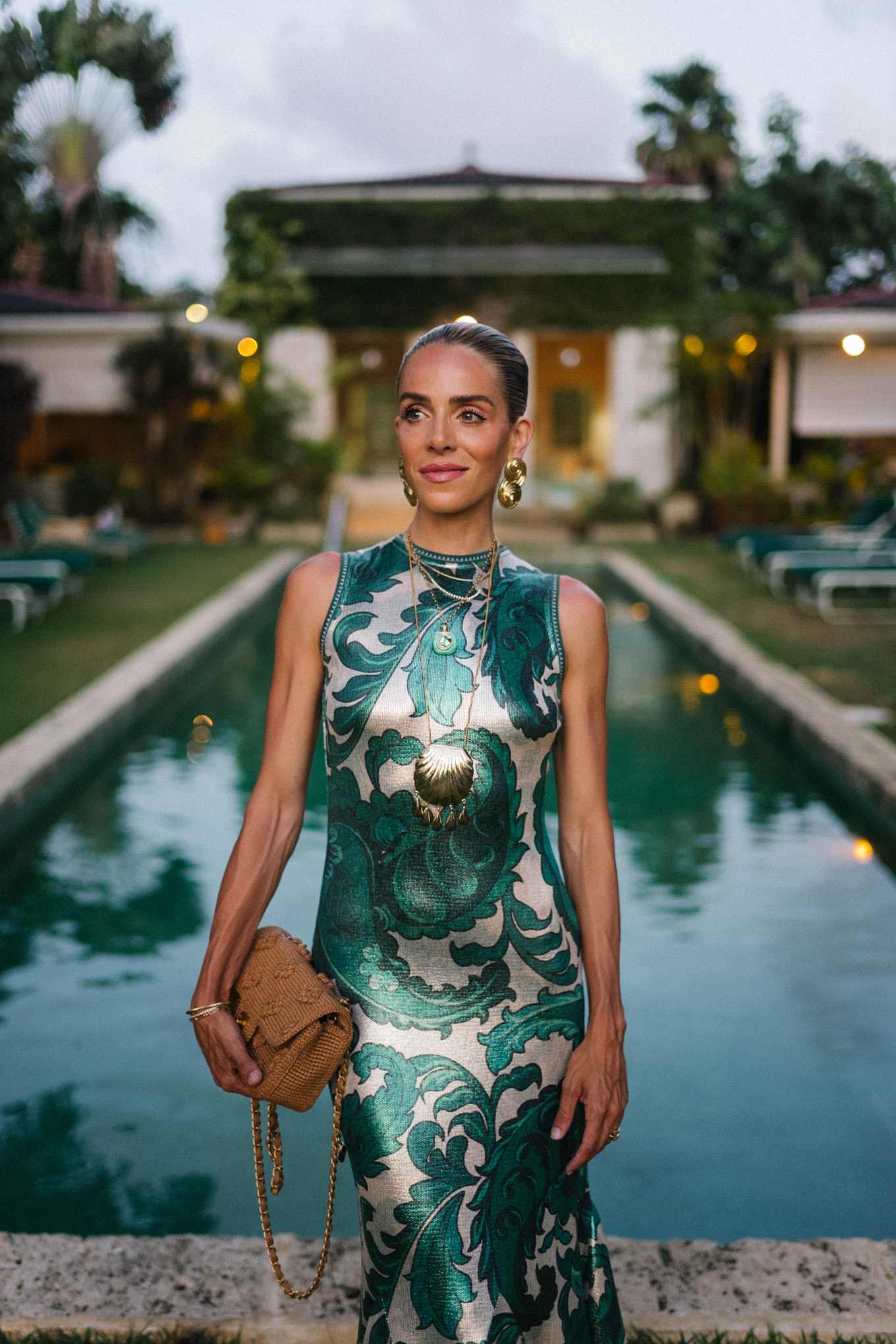 Barbados Sparkly Green Paisley Maxi Dressed in gold slopes of gold fabric bag