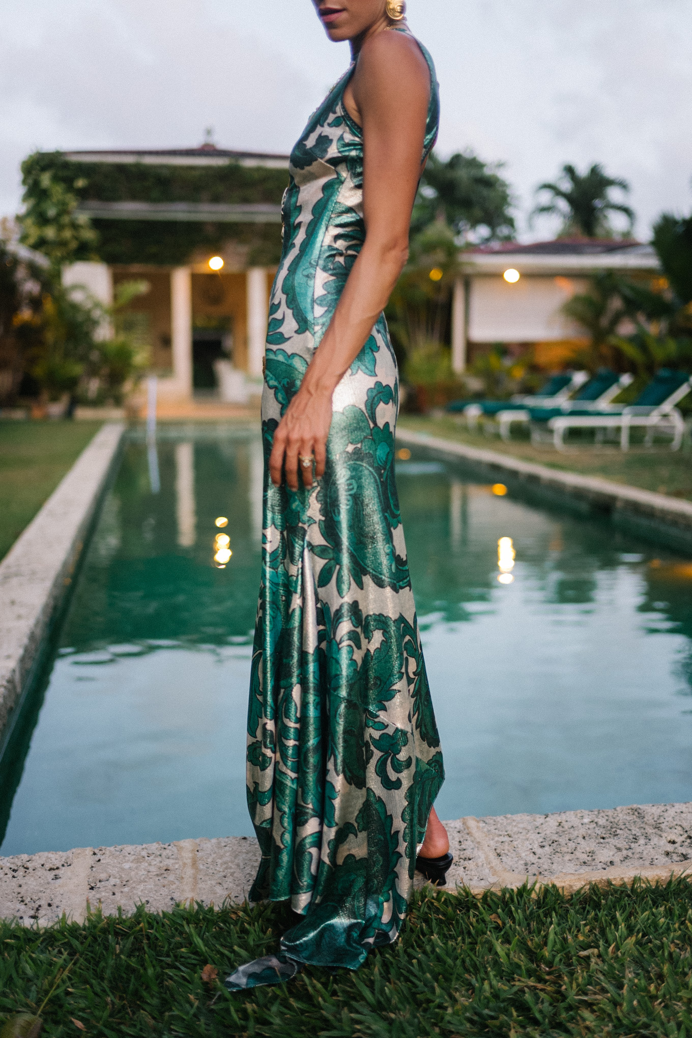 Barbados Sparkly Green Paisley Maxi Dressed in gold slopes of gold fabric bag