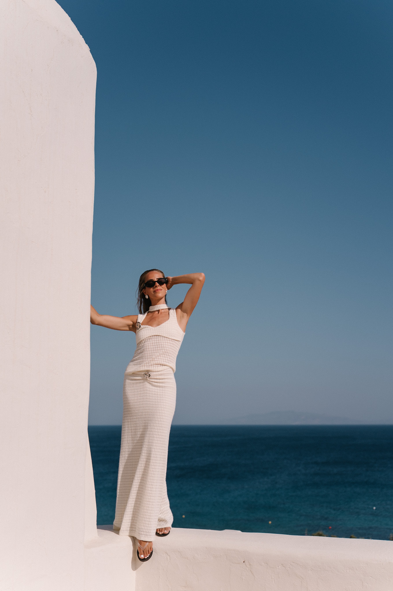 cream crochet halter tank with matching maxi skirt black sunglasses