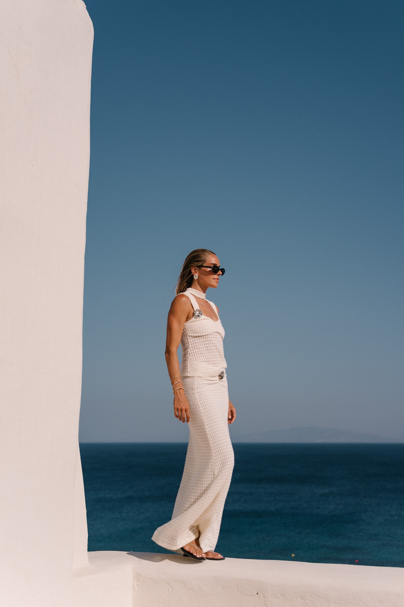cream crochet halter tank with matching maxi skirt black sunglasses