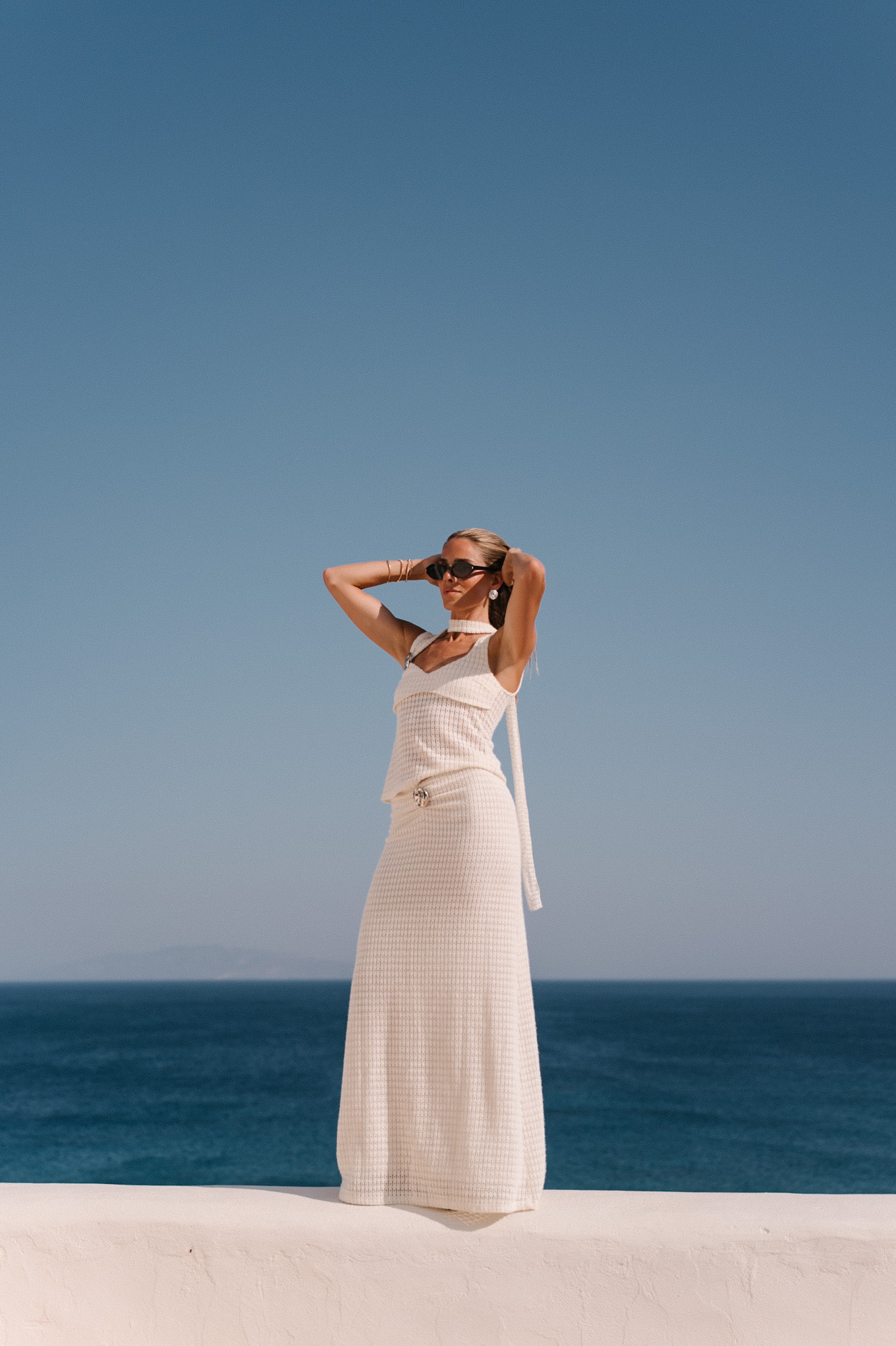 cream crochet halter tank with matching maxi skirt black sunglasses