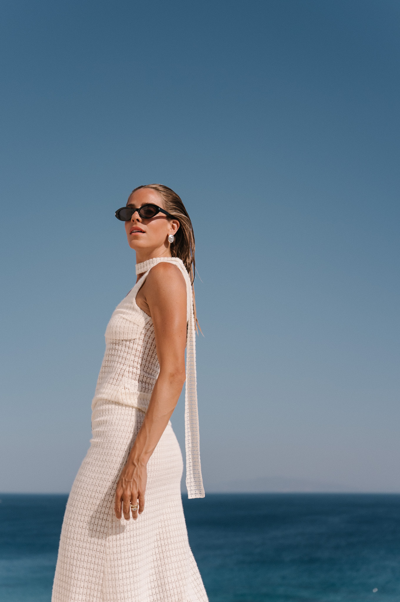 cream crochet halter tank with matching maxi skirt black sunglasses
