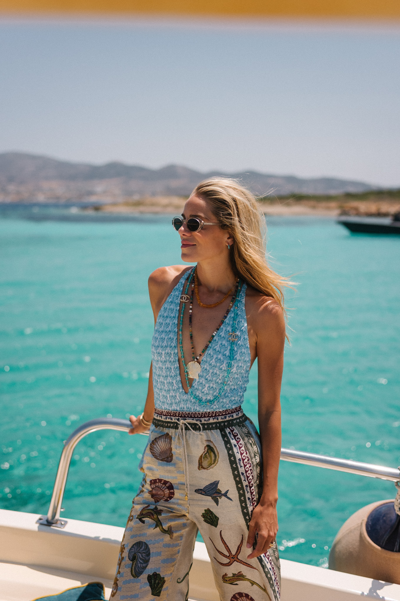 blue one piece swim seashell silk beach pants blue oxford shirt coastal necklaces