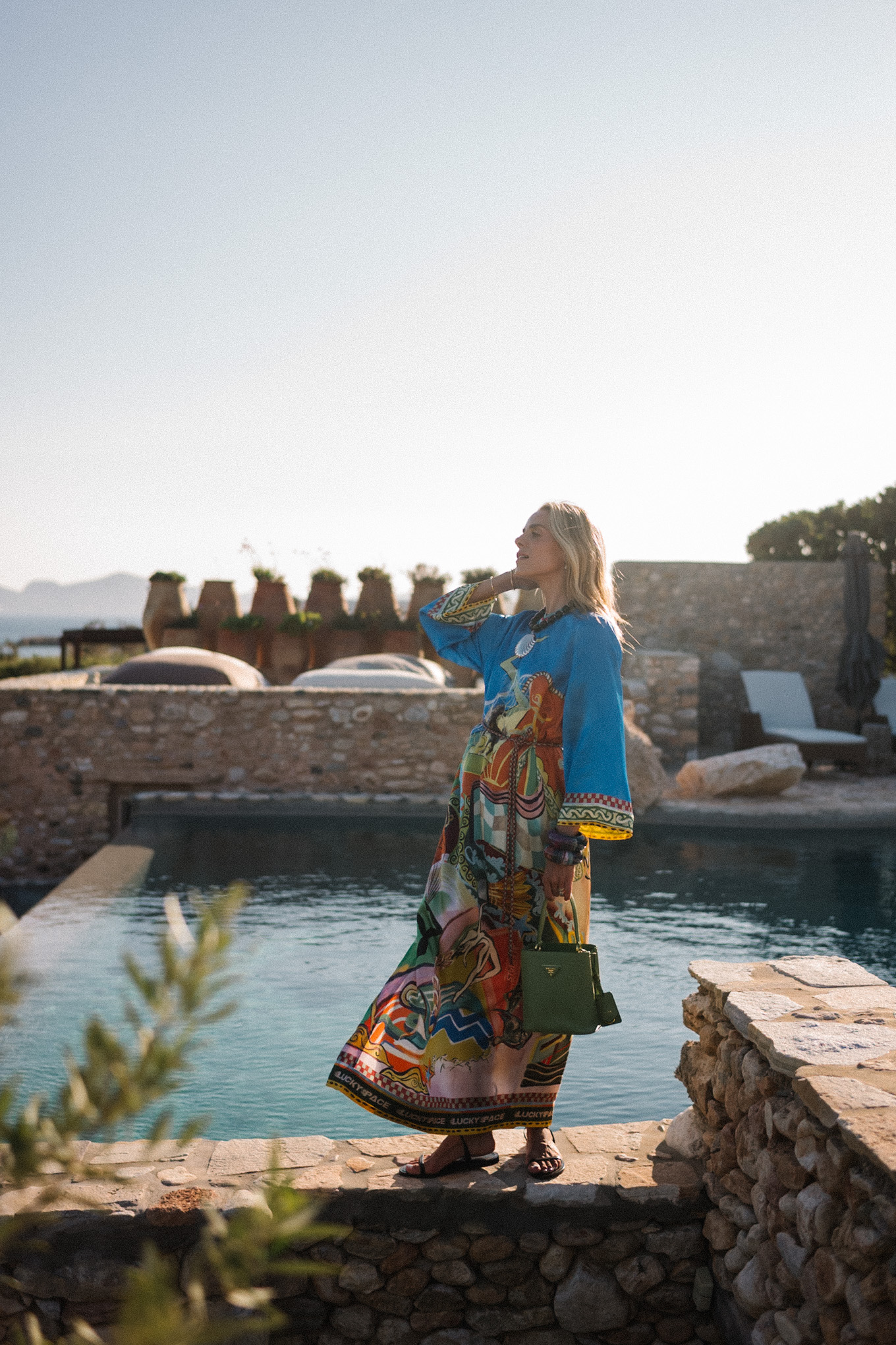 blue silk kaftan black beaded seashell necklace black strappy sandals