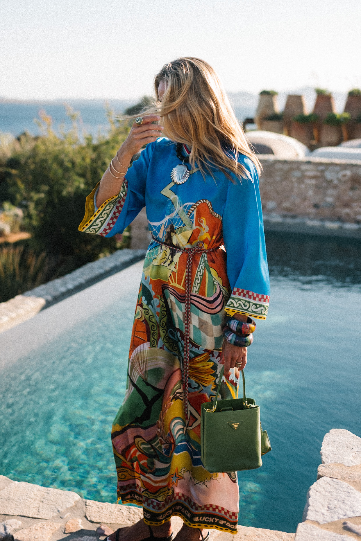 blue silk kaftan black beaded seashell necklace black strappy sandals