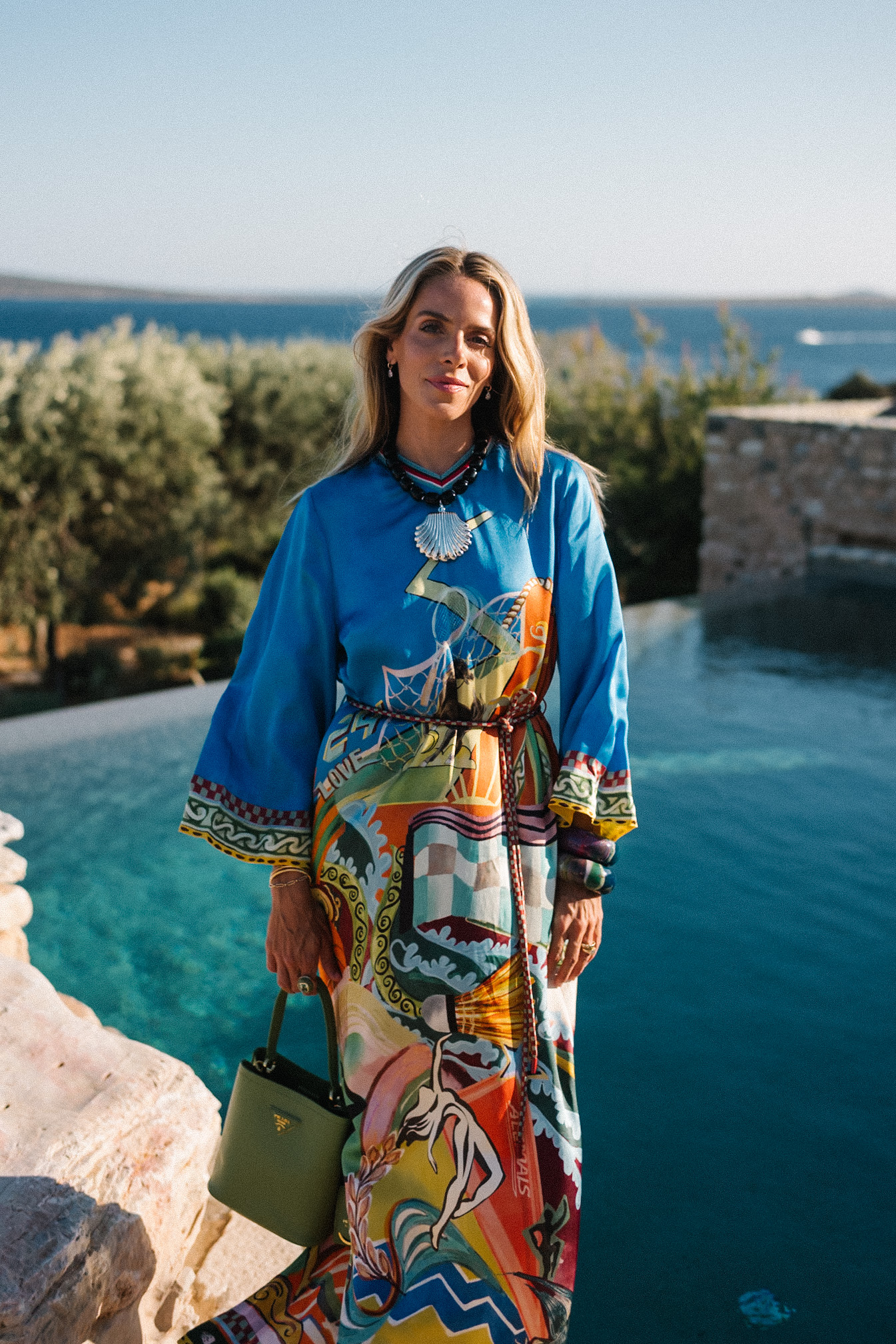 blue silk kaftan black beaded seashell necklace black strappy sandals