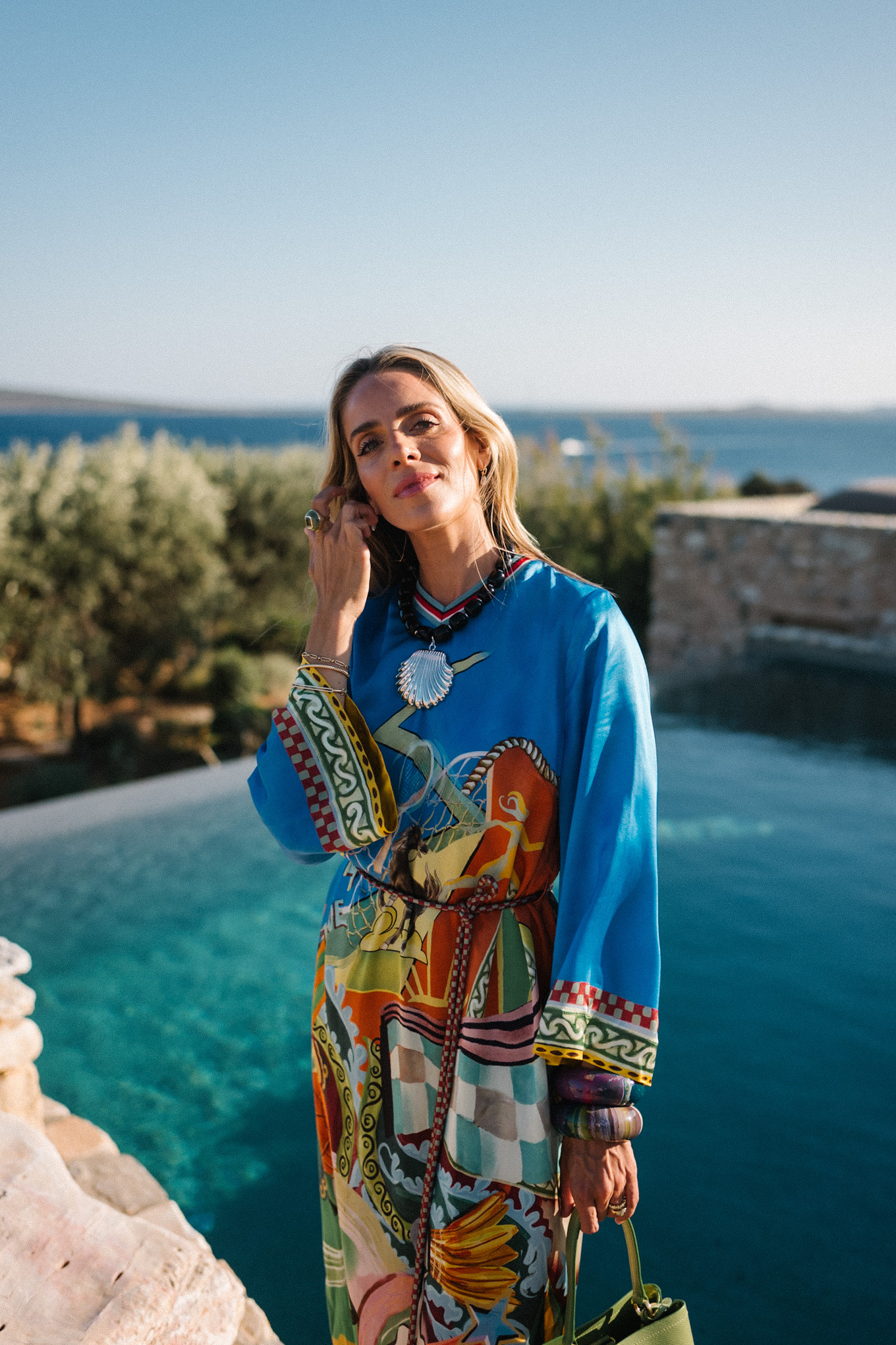 blue silk kaftan black beaded seashell necklace black strappy sandals