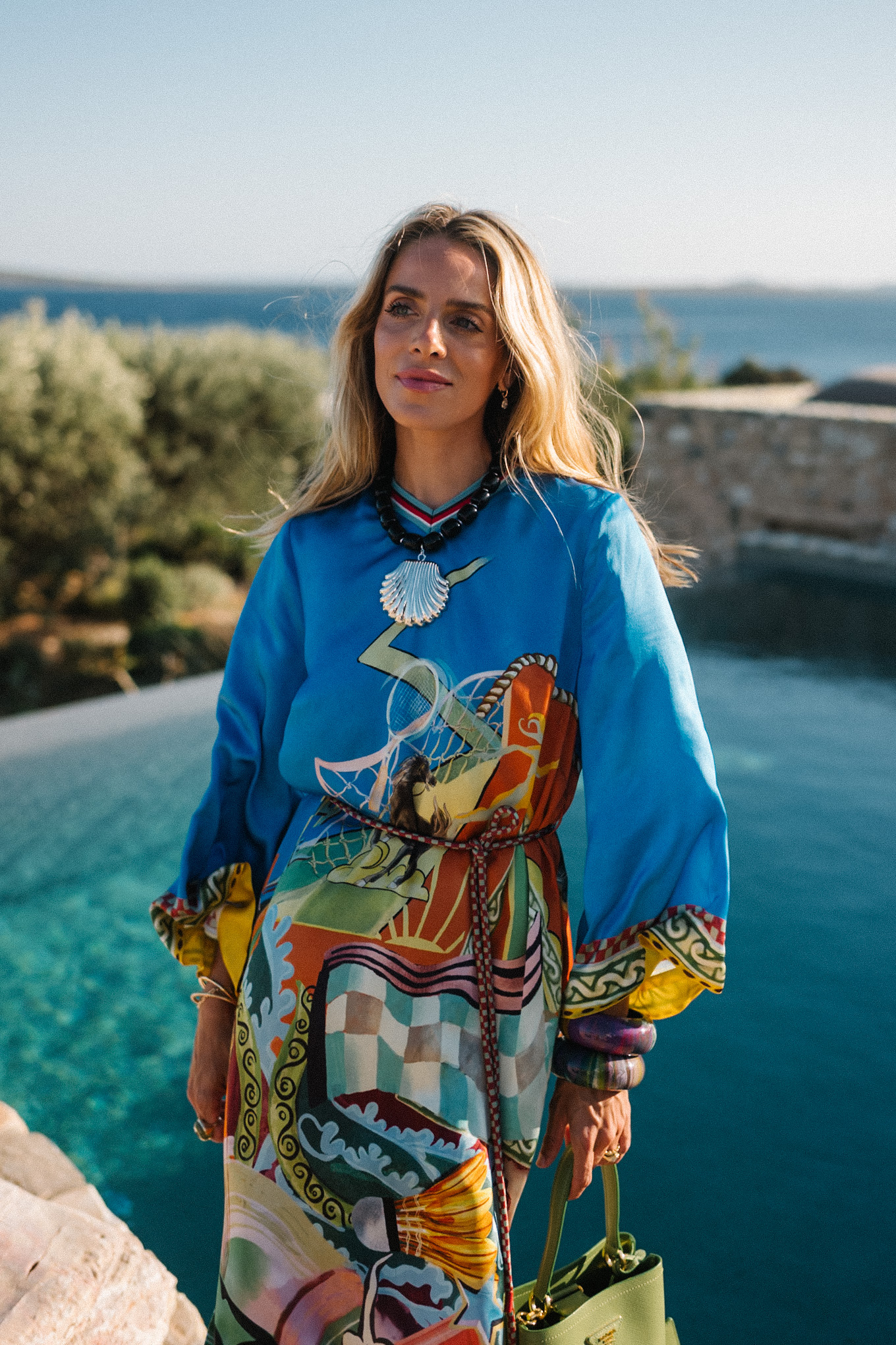 blue silk kaftan black beaded seashell necklace black strappy sandals