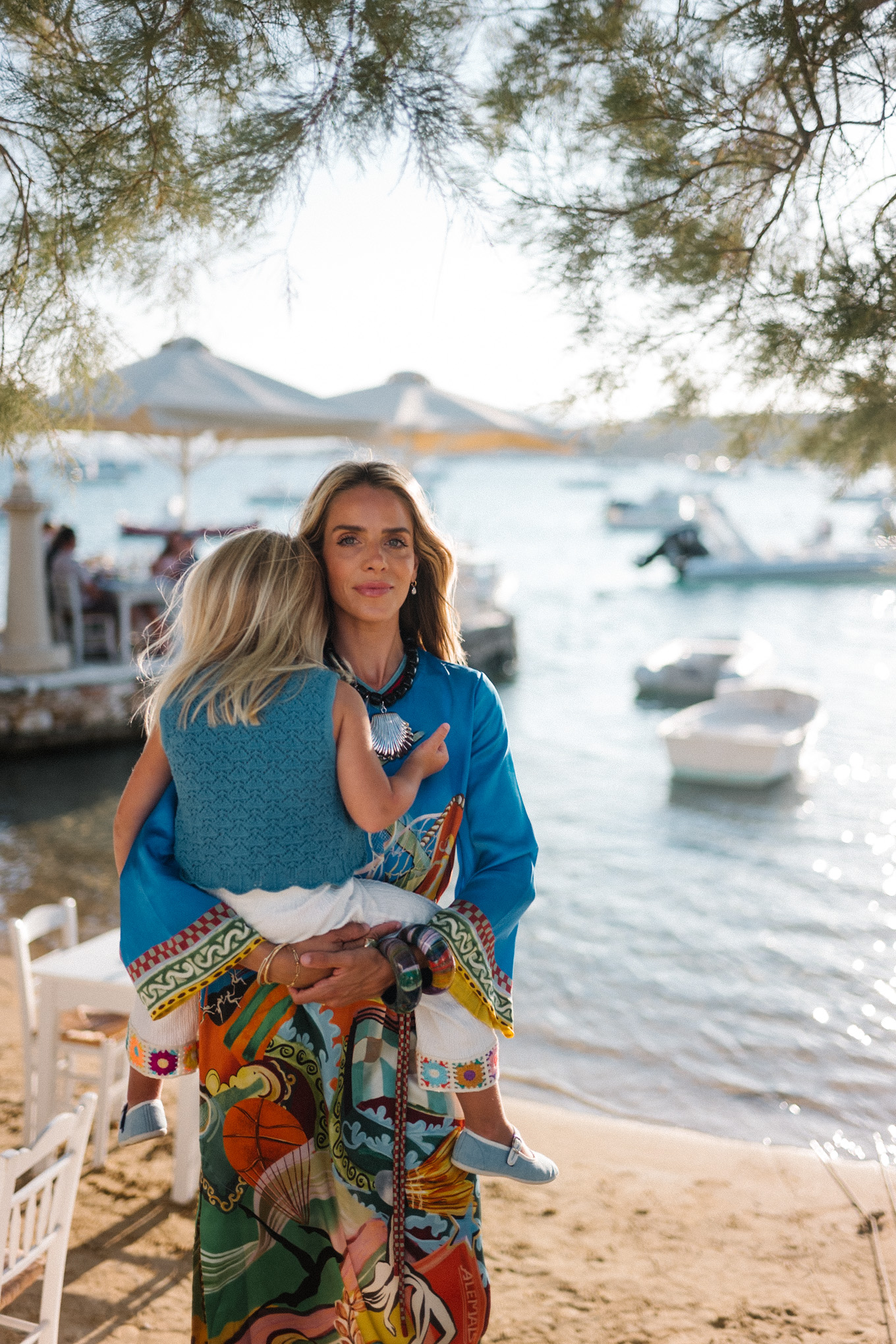 blue silk kaftan black beaded seashell necklace black strappy sandals