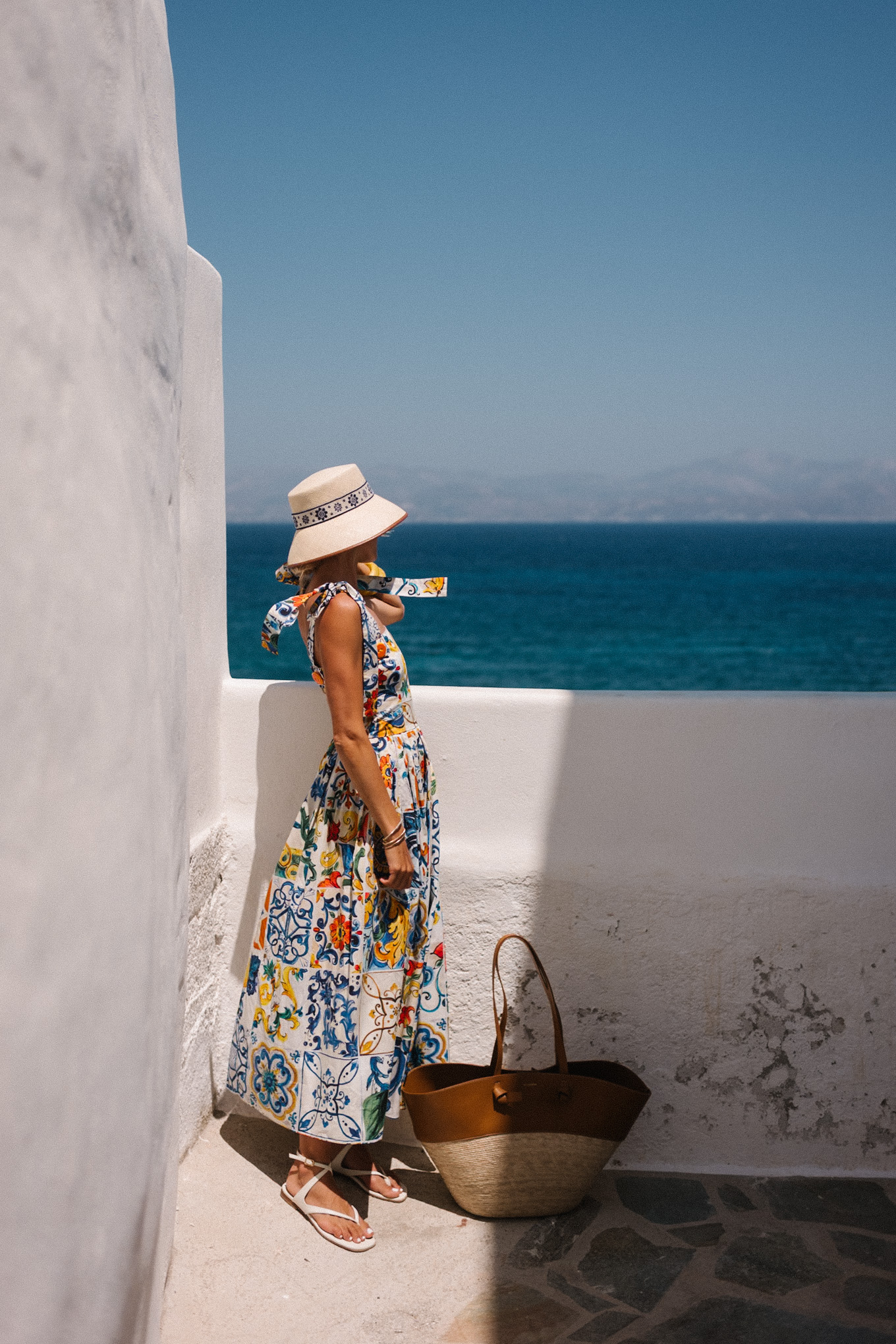 mosaic sundress raffia bucket hat raffia and leather tote white sandals
