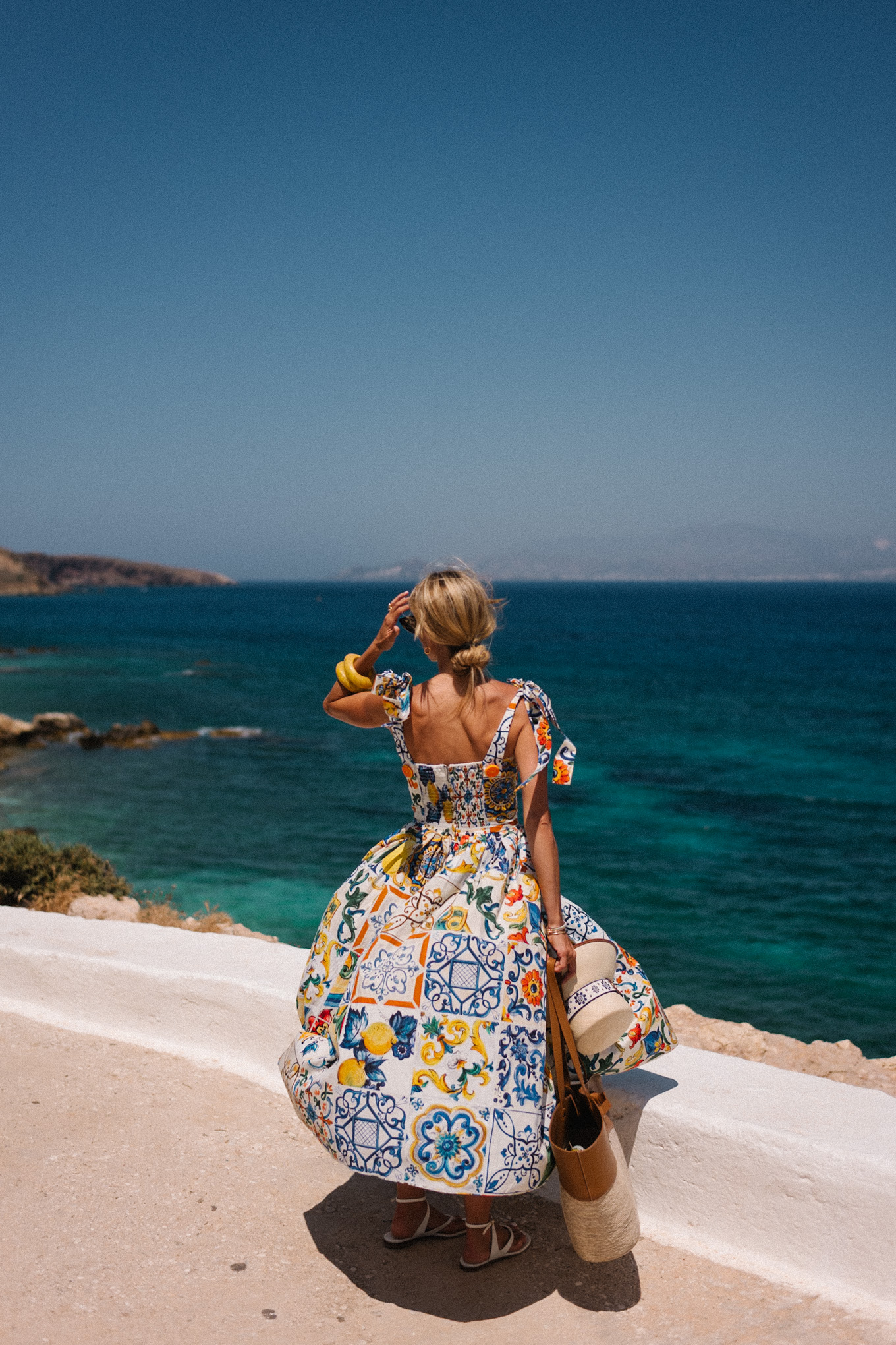 mosaic sundress raffia bucket hat raffia and leather tote white sandals