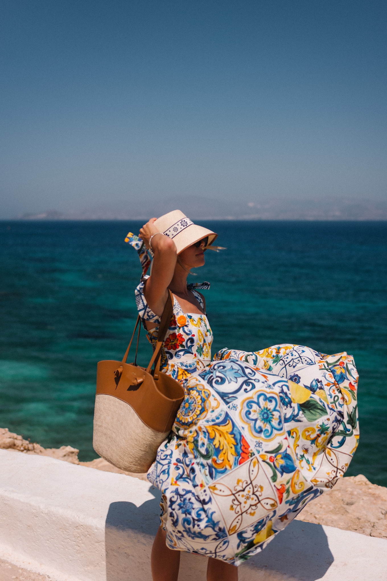 mosaic sundress raffia bucket hat raffia and leather tote white sandals