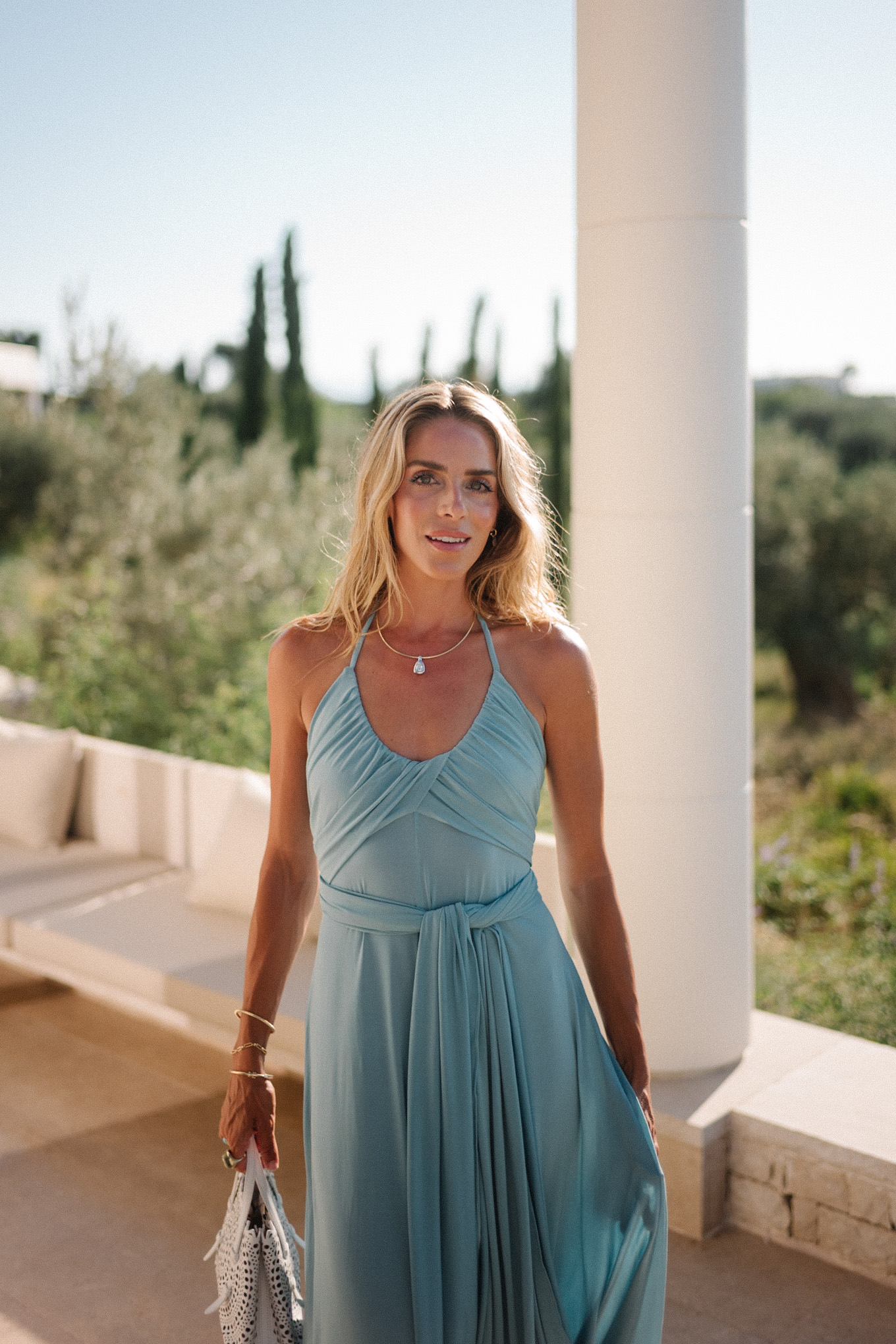 turquoise halter jersey maxi dress white leather cut out bag white leather heeled sandals