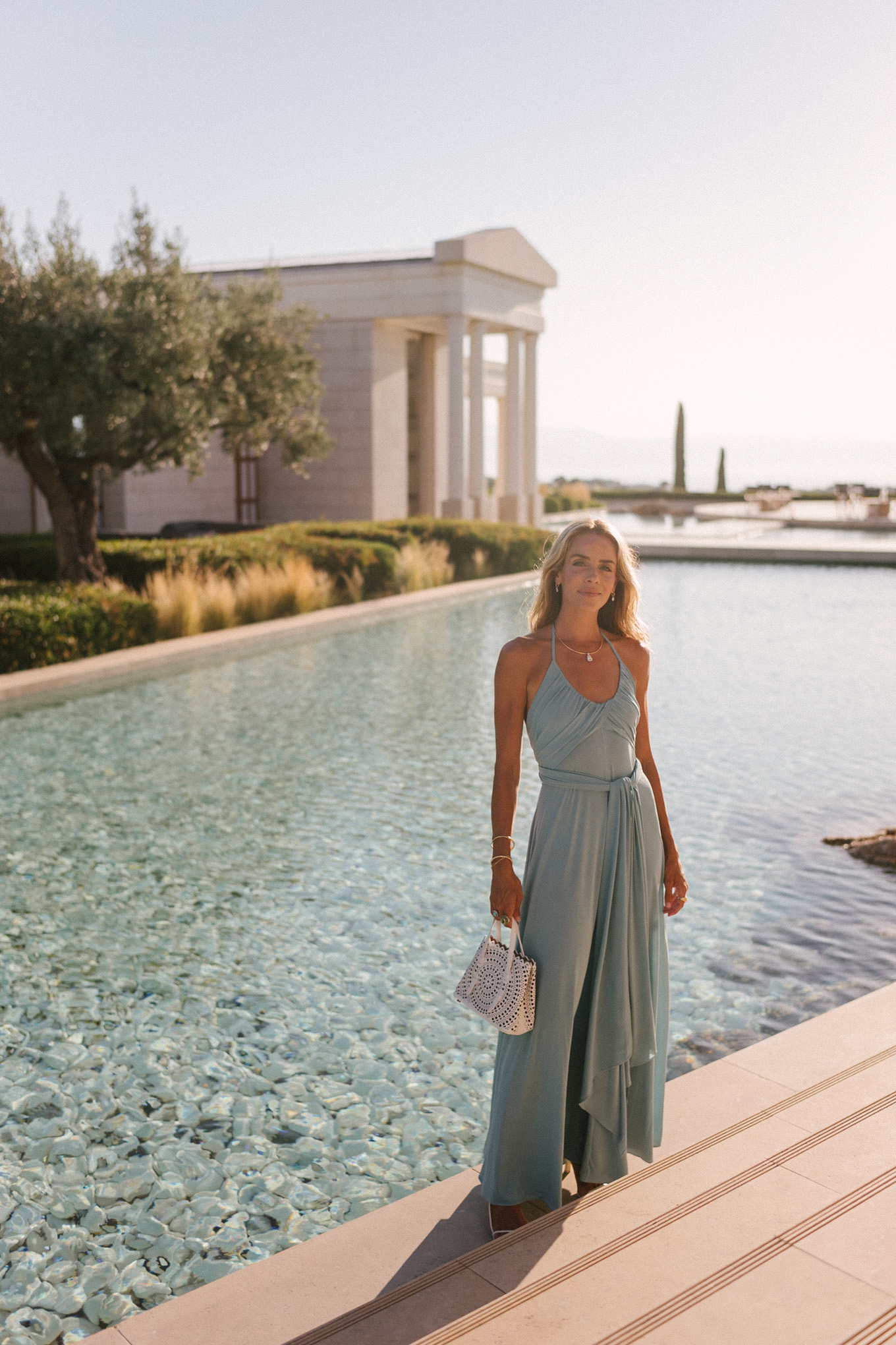 turquoise halter jersey maxi dress white leather cut out bag white leather heeled sandals