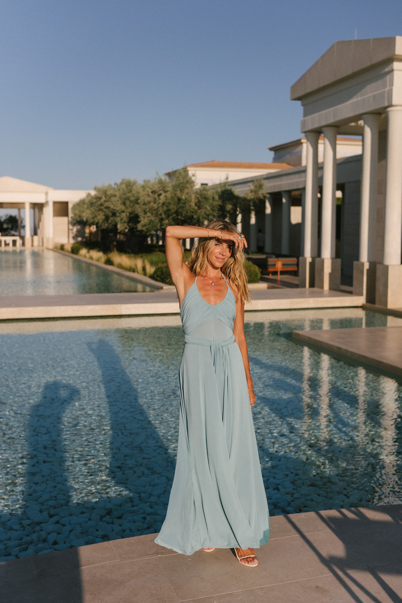 turquoise halter jersey maxi dress white leather cut out bag white leather heeled sandals