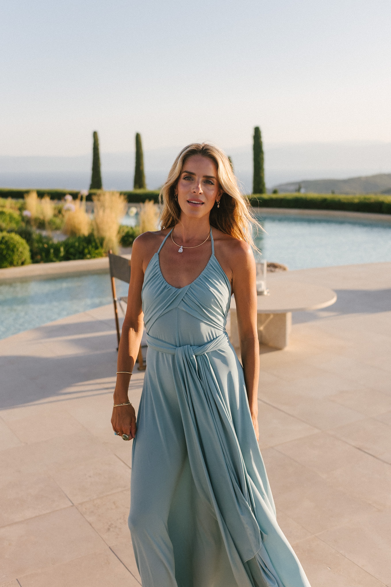 turquoise halter jersey maxi dress white leather cut out bag white leather heeled sandals