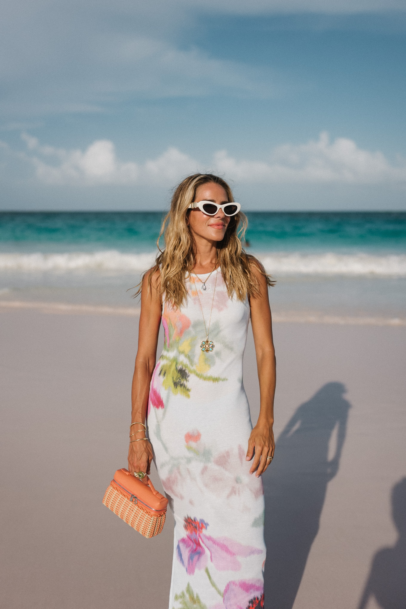 white floral jersey midi dress orange raffia handbag white sunglasses