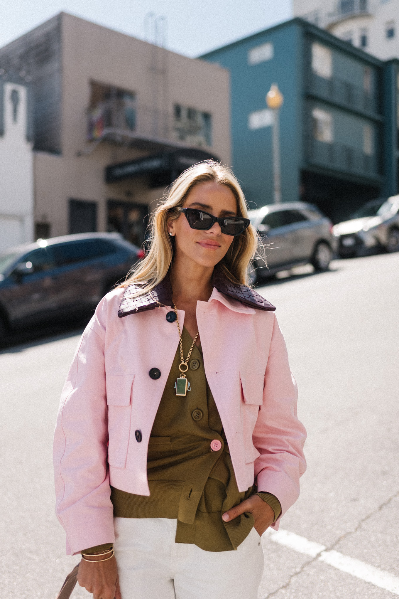 pink cropped barn jacket white denim green sweater green sneakers