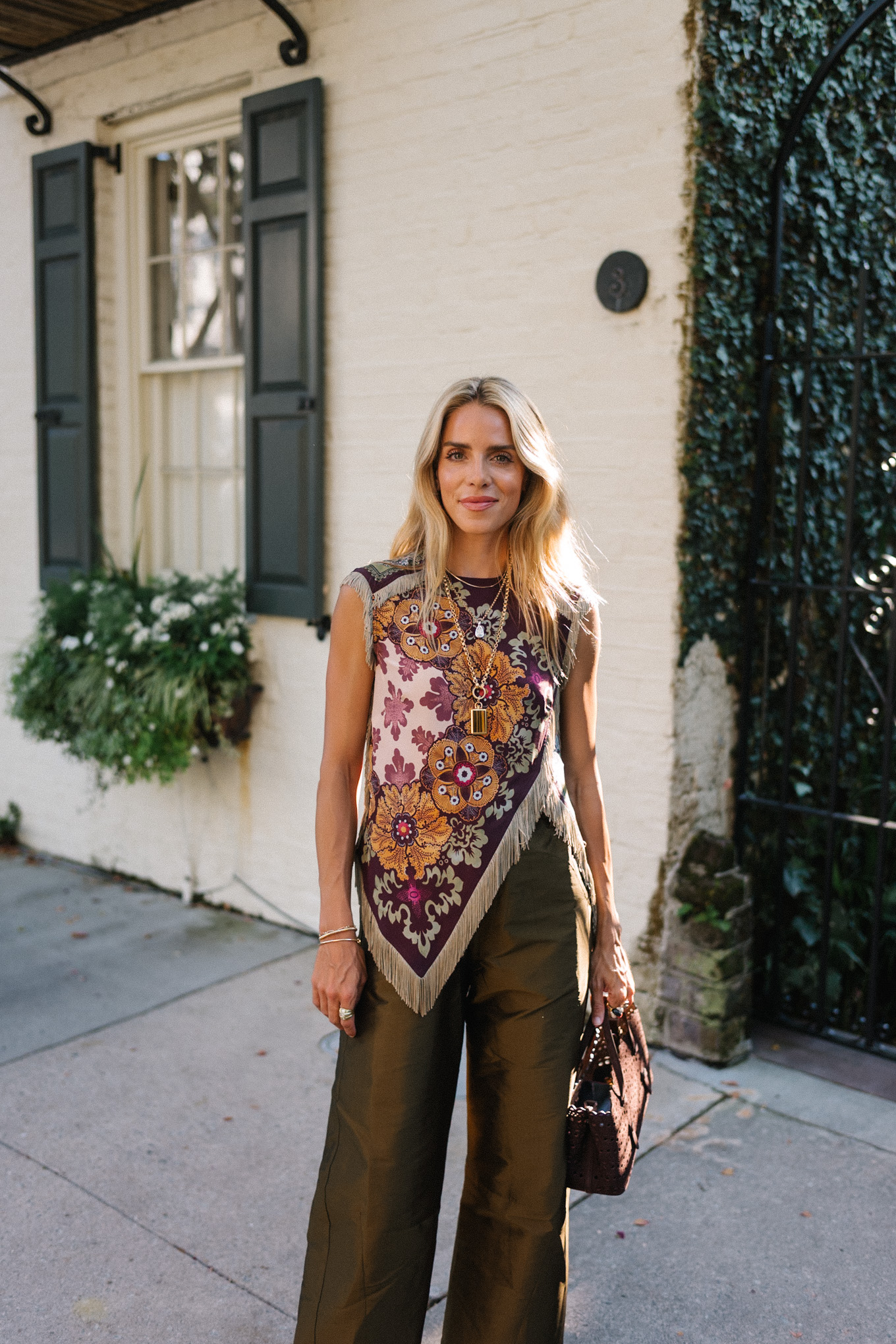 purple floral scarf top brown satin pants brown handbag orange mules