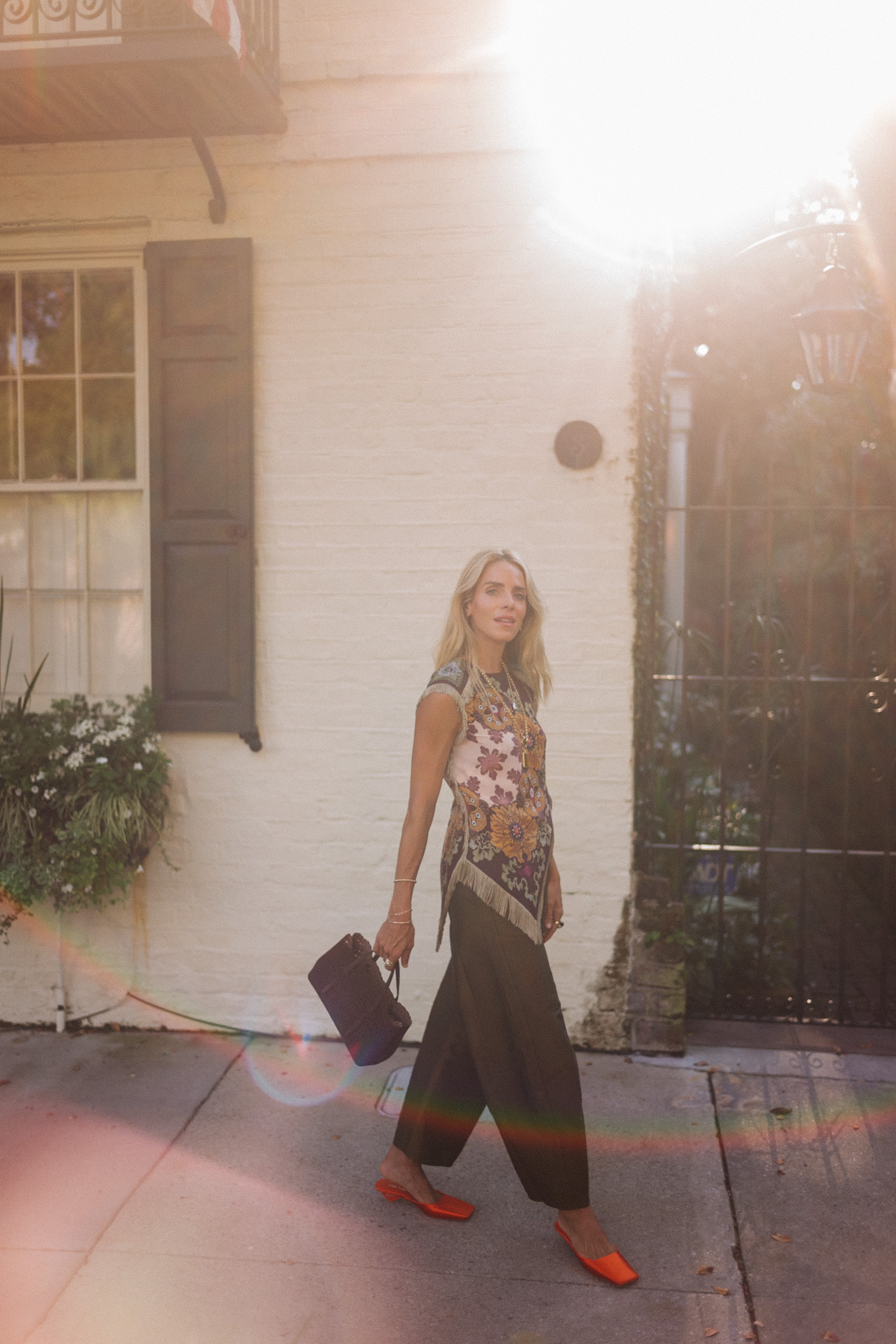 purple floral scarf top brown satin pants brown handbag orange mules