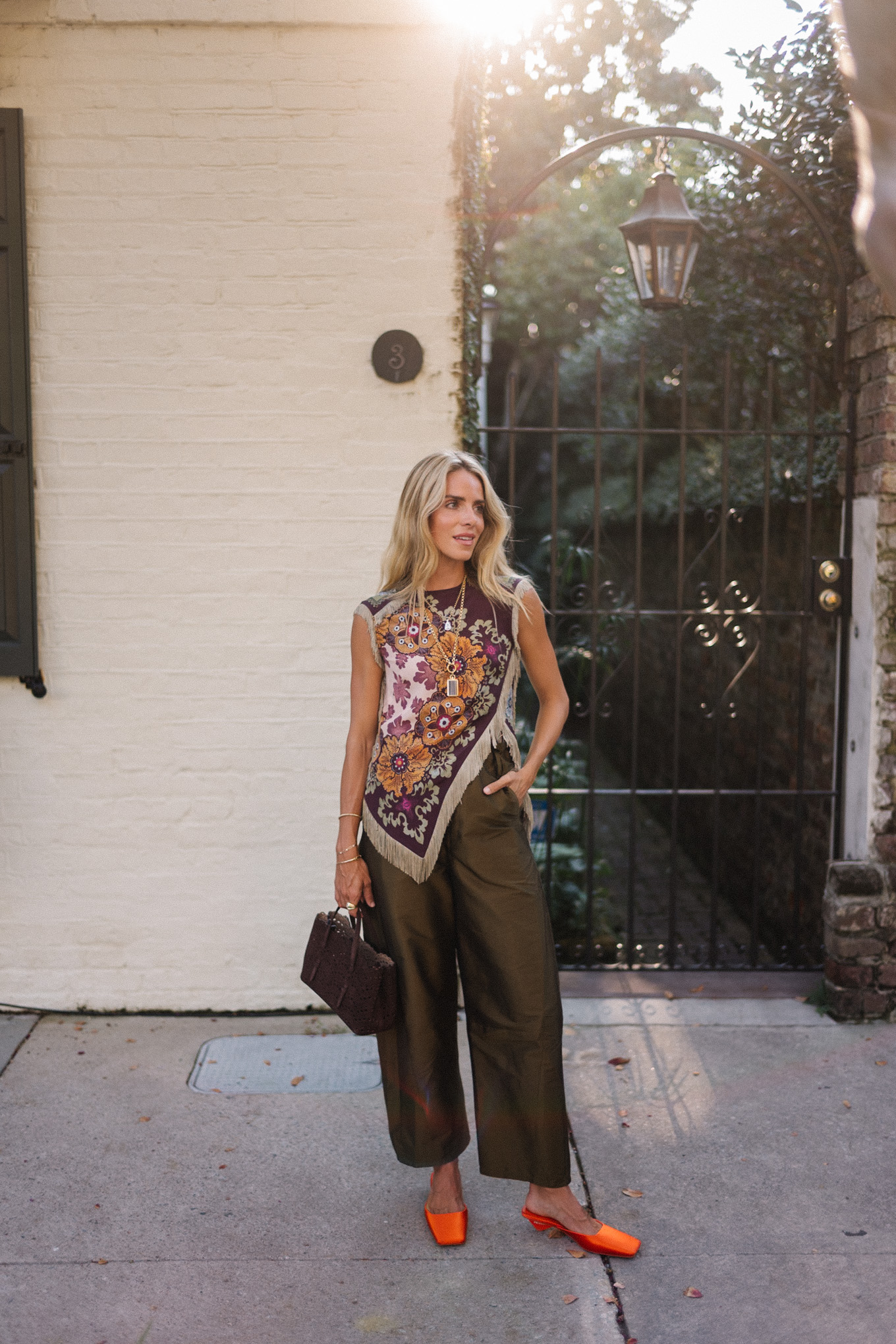 purple floral scarf top brown satin pants brown handbag orange mules