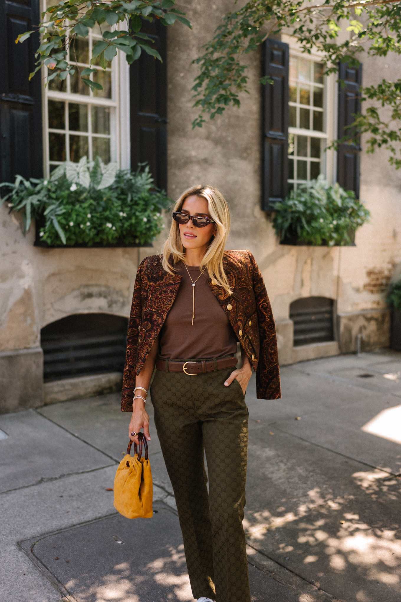 brown paisley jacket brown tank moss green pants brown suede sneakers gold suede bag