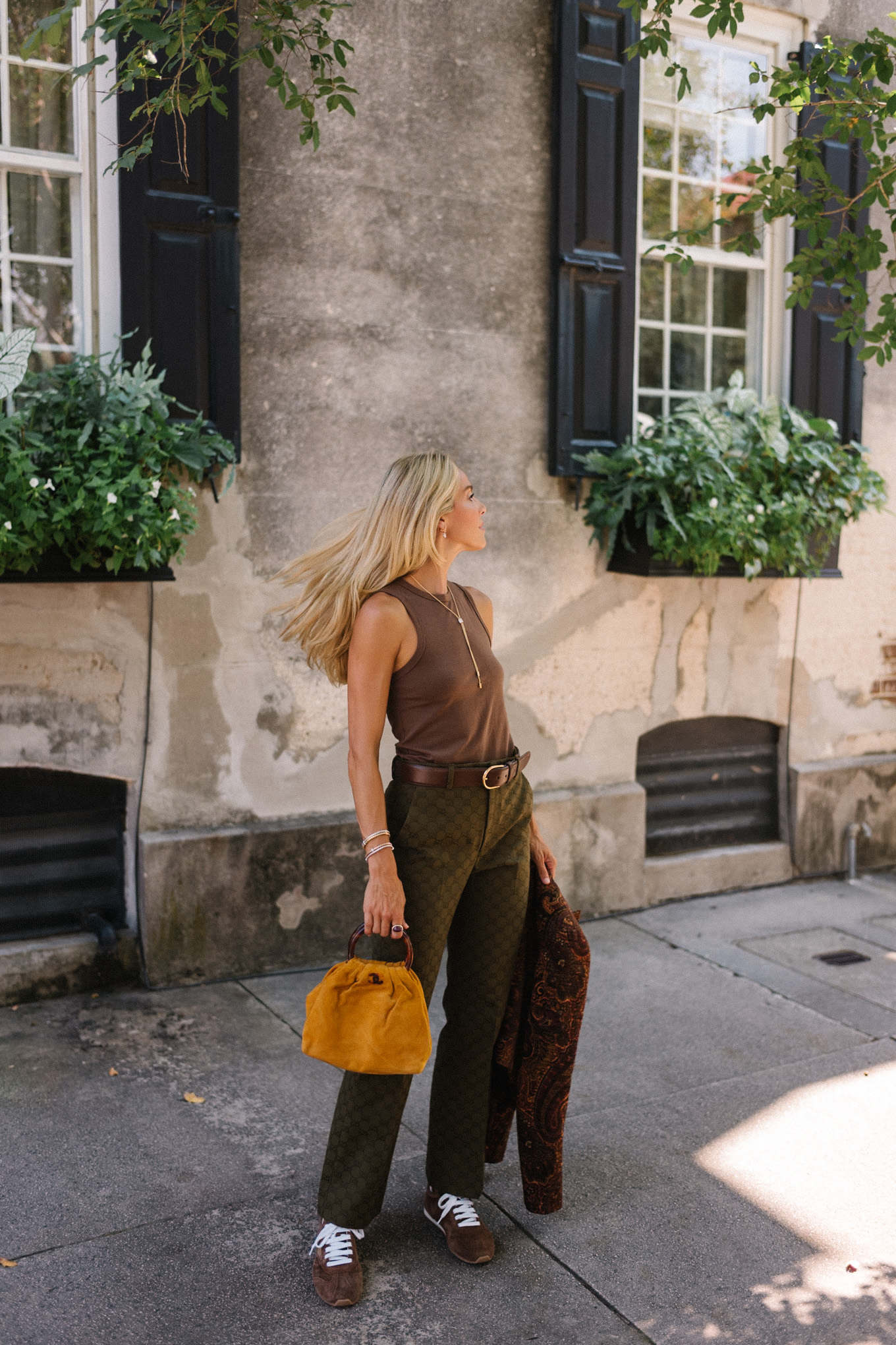 brown paisley jacket brown tank moss green pants brown suede sneakers gold suede bag