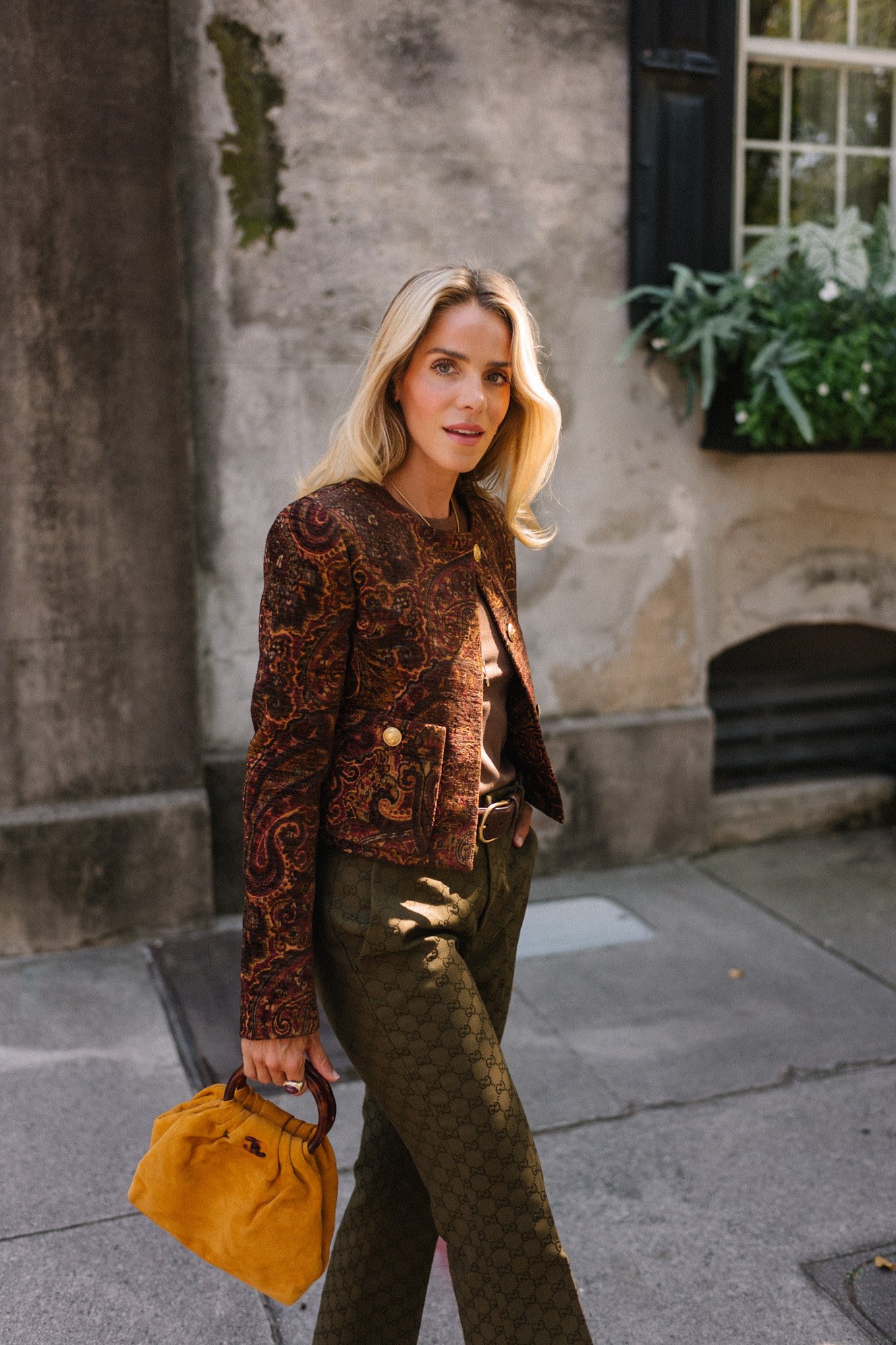 brown paisley jacket brown tank moss green pants brown suede sneakers gold suede bag