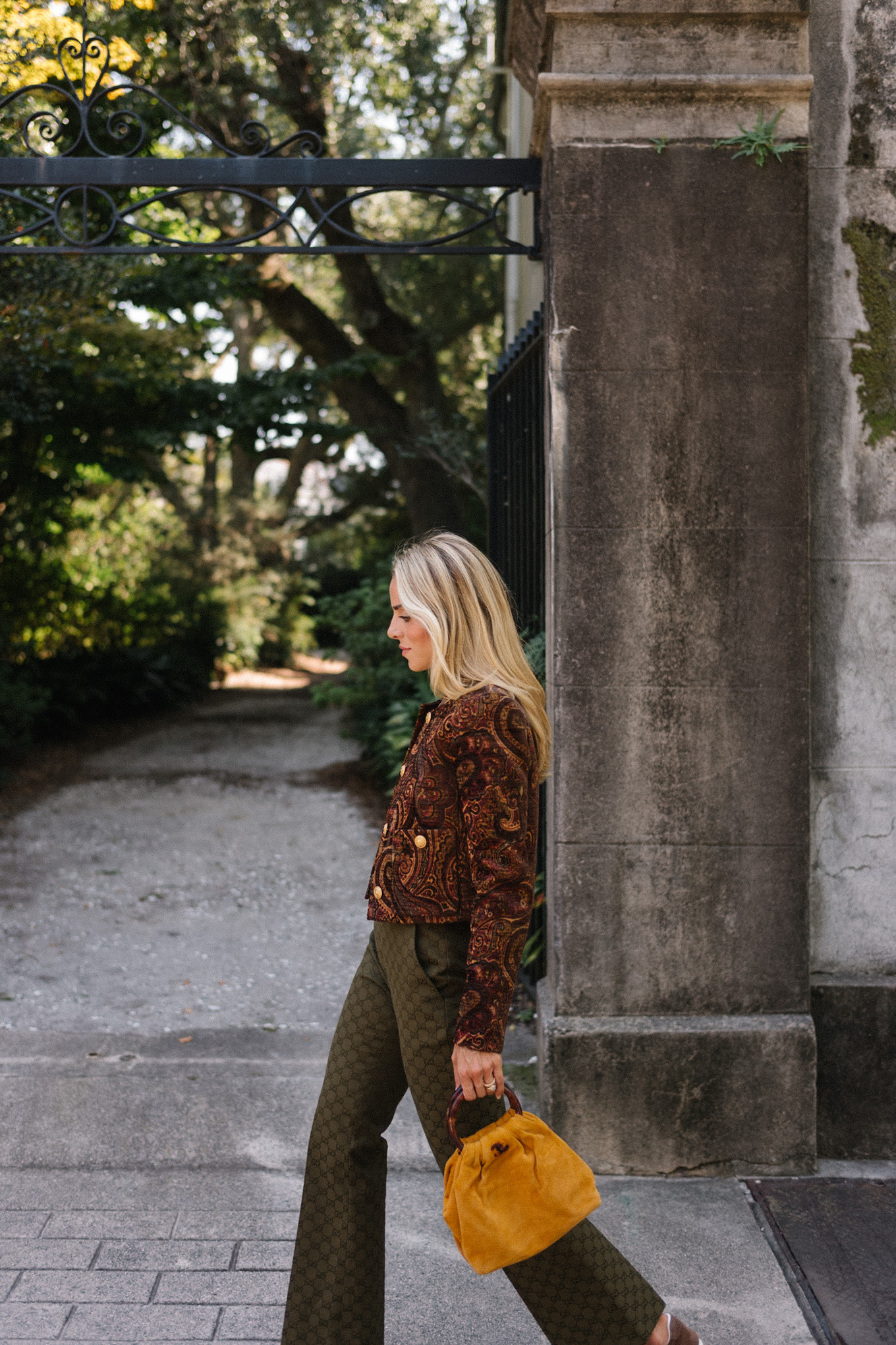 brown paisley jacket brown tank moss green pants brown suede sneakers gold suede bag