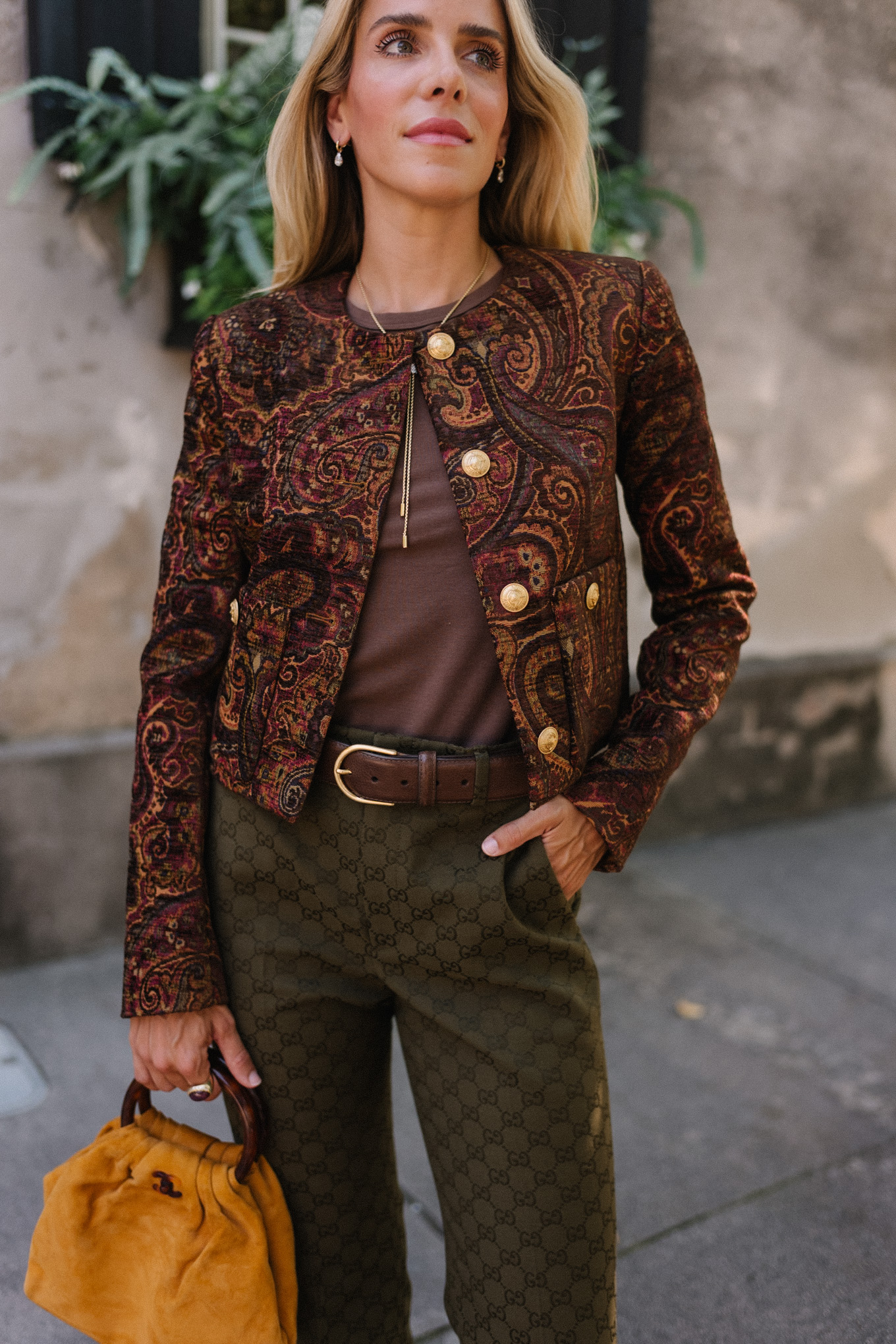 brown paisley jacket brown tank moss green pants brown suede sneakers gold suede bag