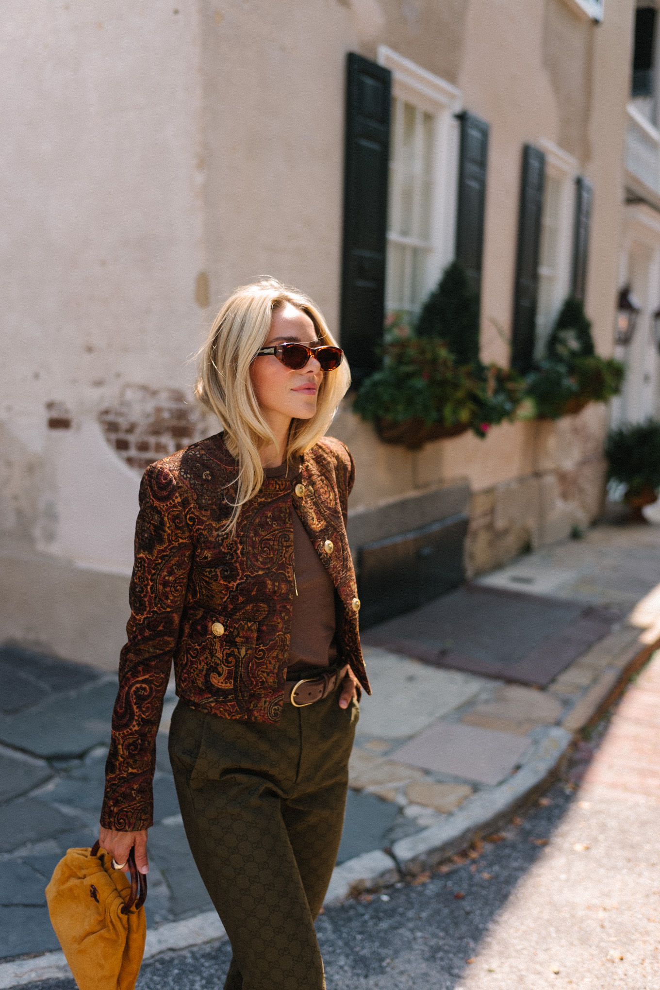 brown paisley jacket brown tank moss green pants brown suede sneakers gold suede bag