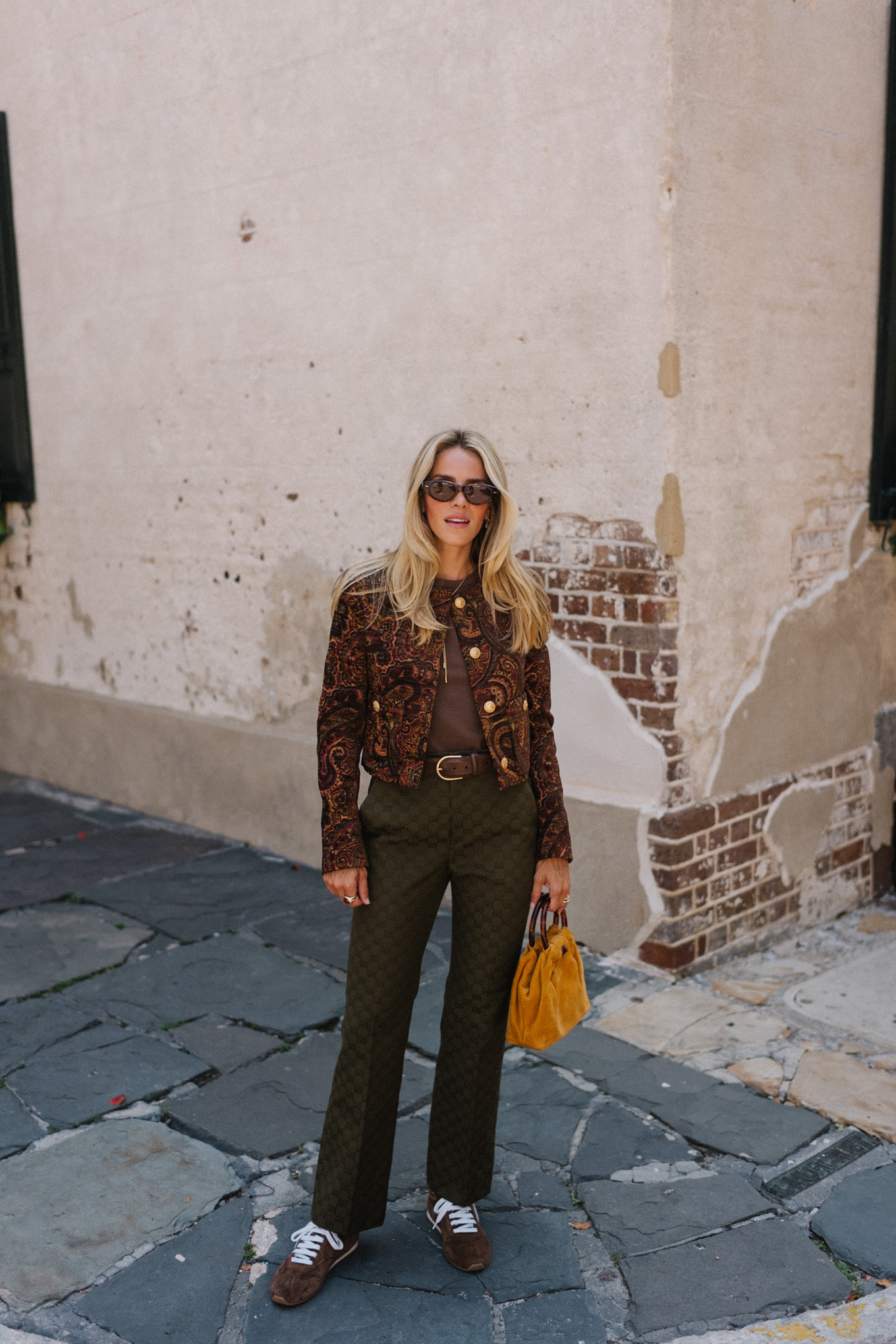 brown paisley jacket brown tank moss green pants brown suede sneakers gold suede bag