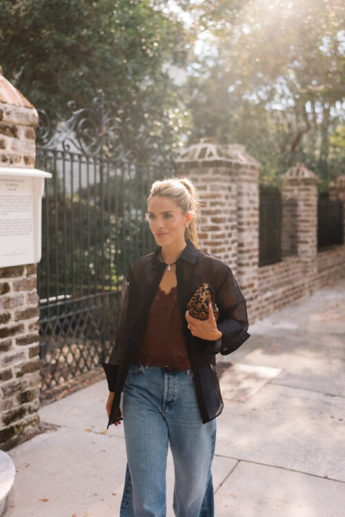 black sheer blouse brown silk cami blue jeans leopard clutch