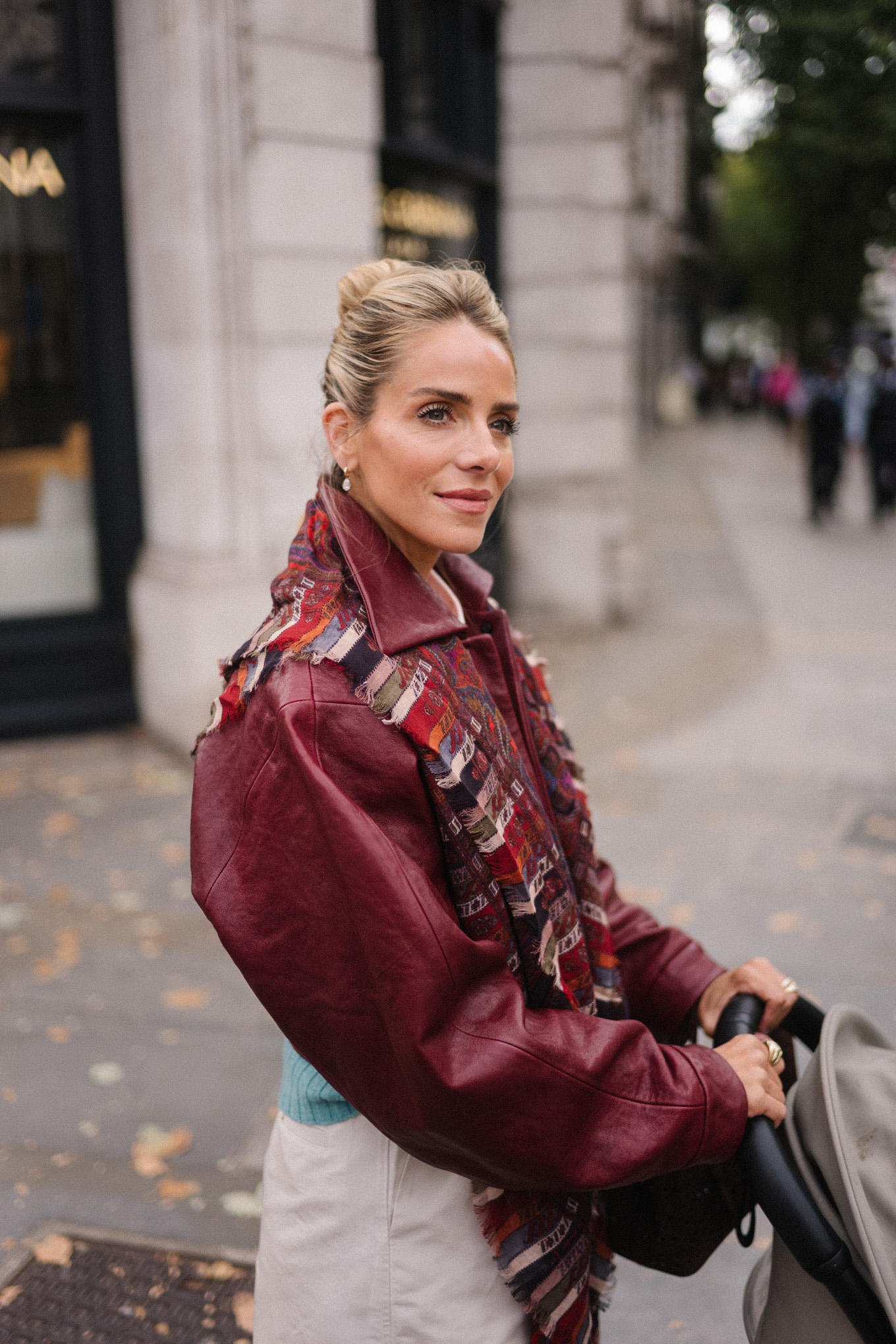 maroon leather jacket striped scarf turquoise sweater white button down shirt cream wide leg pants