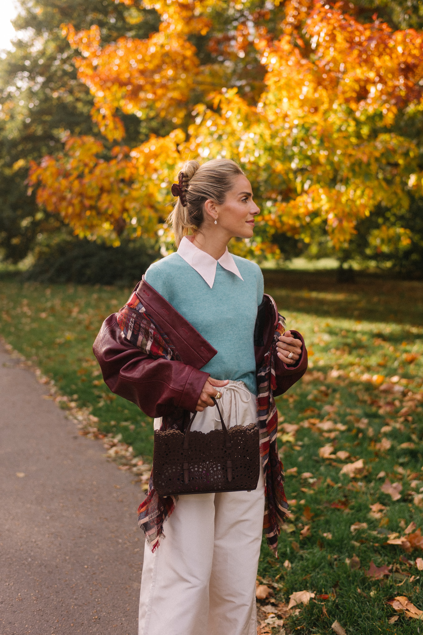 maroon leather jacket striped scarf turquoise sweater white button down shirt cream wide leg pants