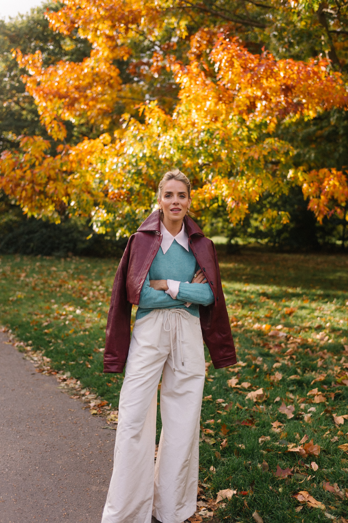 maroon leather jacket striped scarf turquoise sweater white button down shirt cream wide leg pants