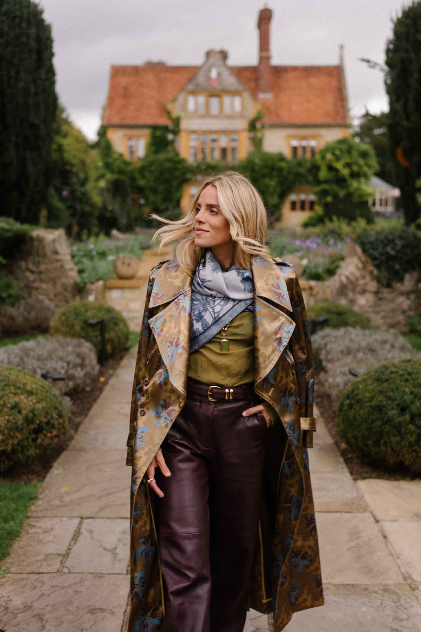 green sheer blouse maroon leather pants blue scarf jacquard trench